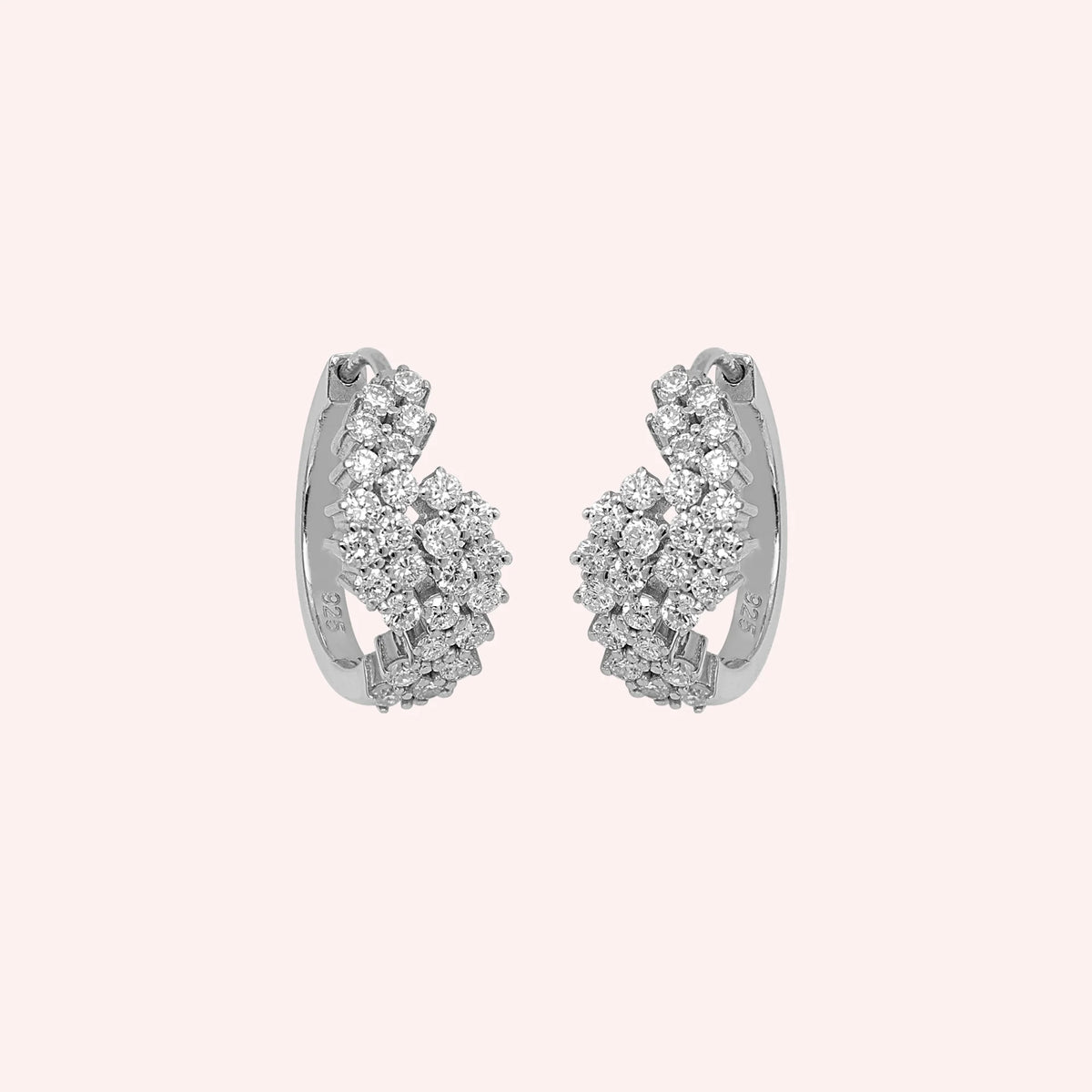 Huggie_earrings_in_sterling_silver_with_lab_grown_diamonds_at_front_angle_view_on_solid_pink_background