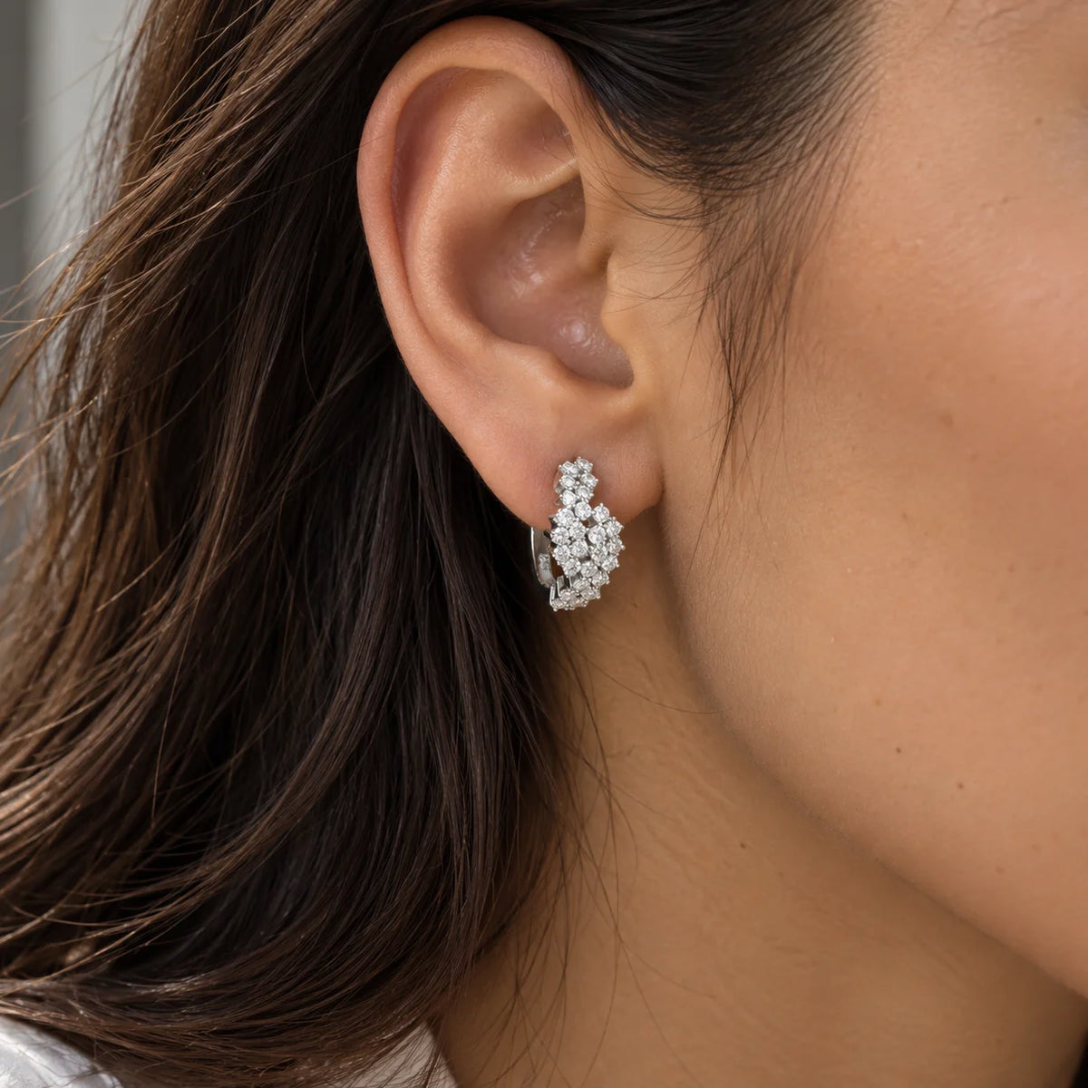 Huggie_earrings_in_sterling_silver_with_lab_grown_diamonds_at_front_angle_view_worn_by_a_model