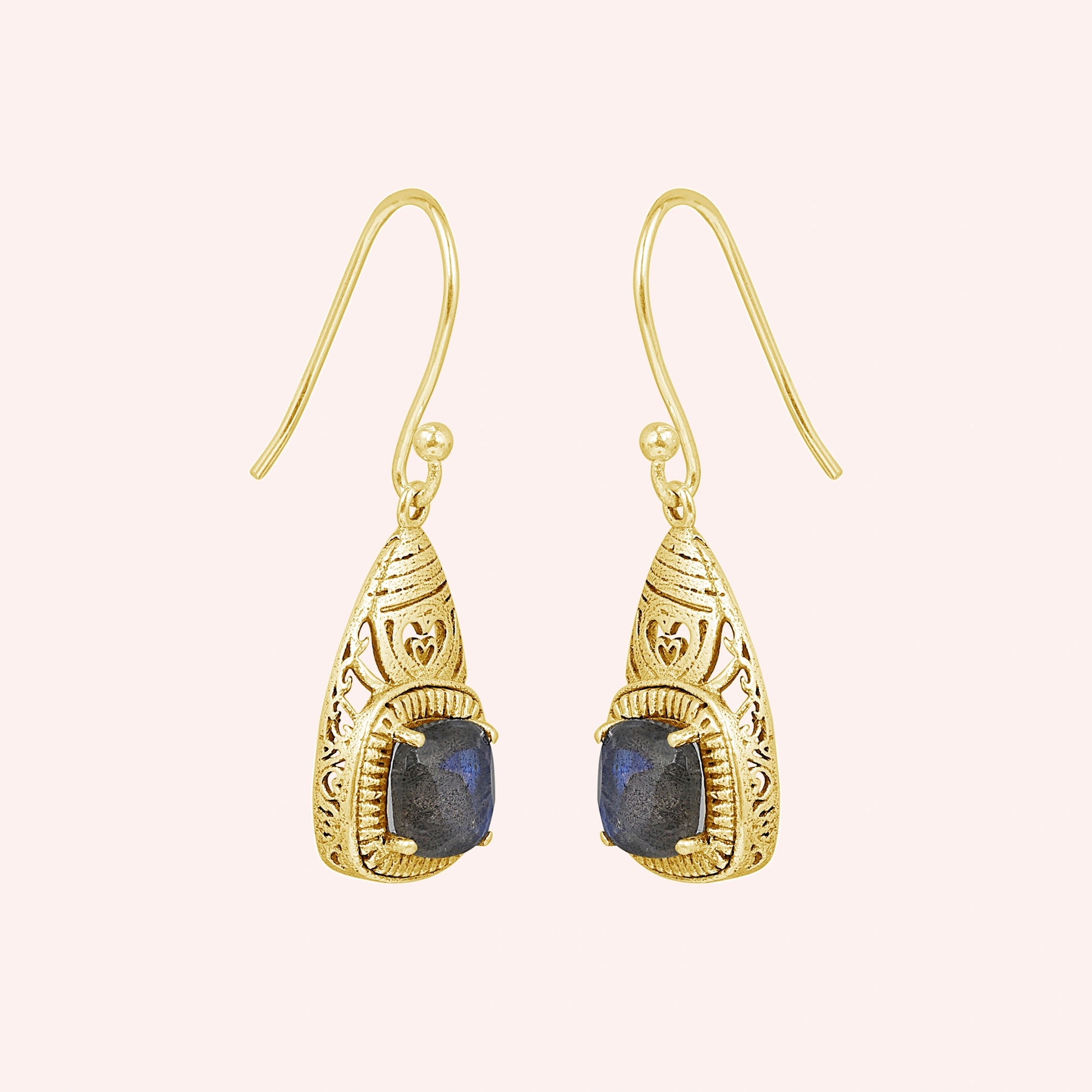 Gold-plated gemstone earring with dangle design and labradorite stone on a slight angle view on light pink background