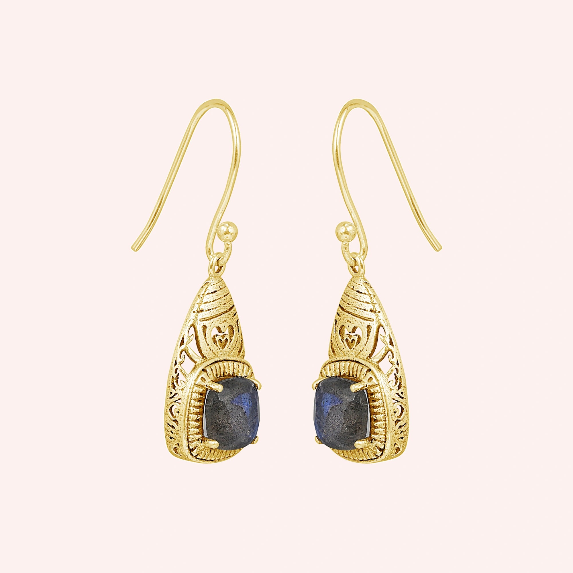 Gold-plated gemstone earring with dangle design and labradorite stone on a slight angle view on light pink background