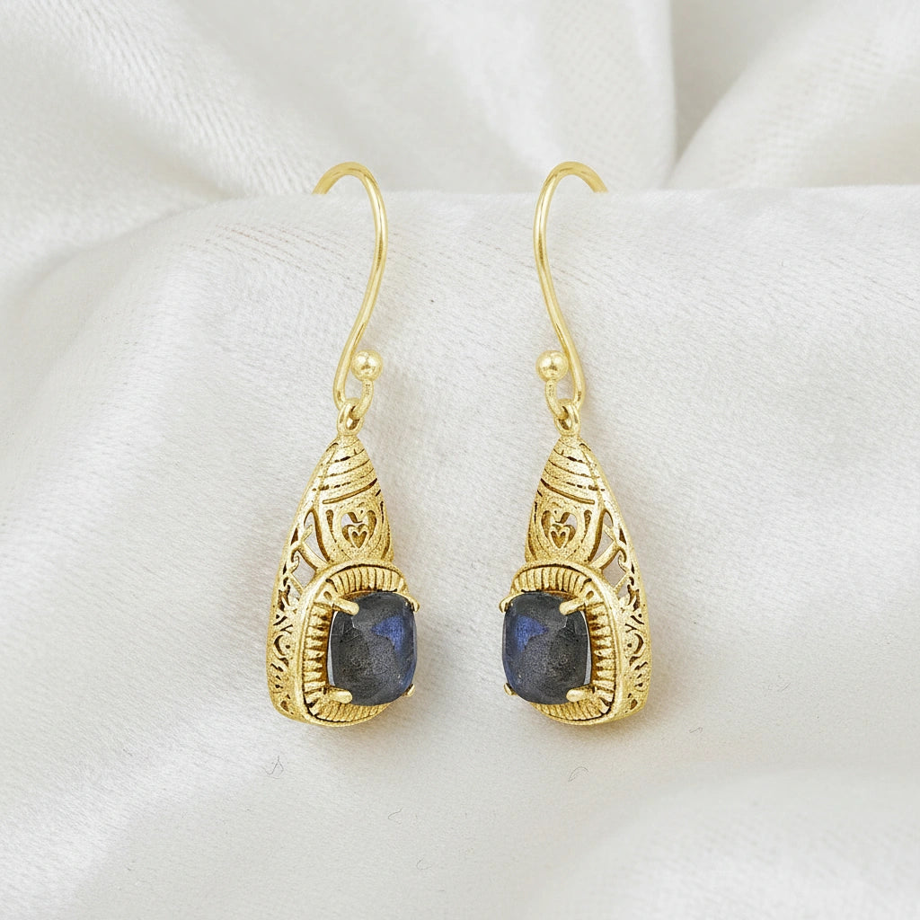 Gold plated gemstone earrings detailed silver filigree dangle design featuring square labradorite viewed straight on white cloth