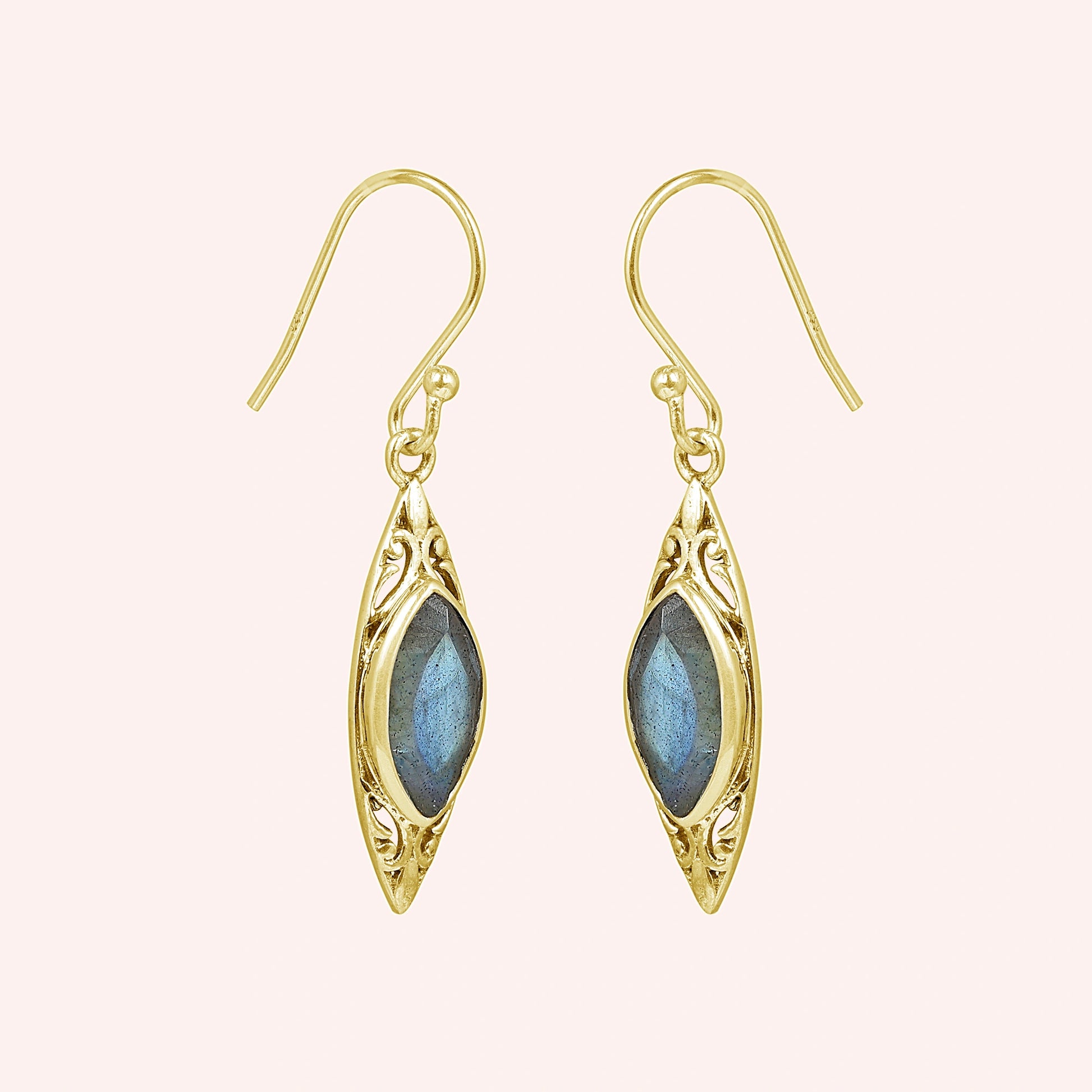 Gold plated marquise earrings dangle design with carved setting and central labradorite viewed straight on pink background