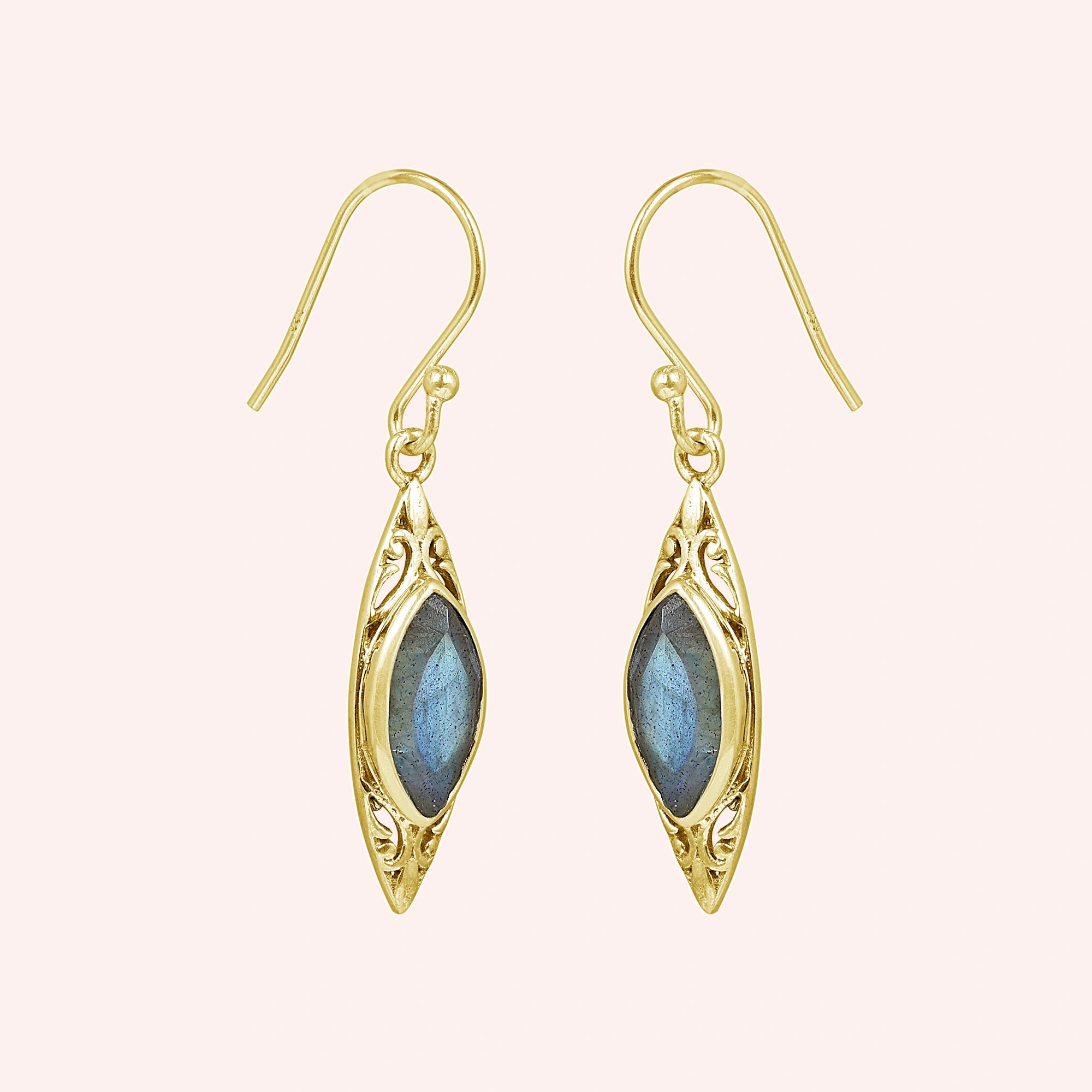 Gold plated marquise earrings dangle design with carved setting and central labradorite viewed straight on pink background