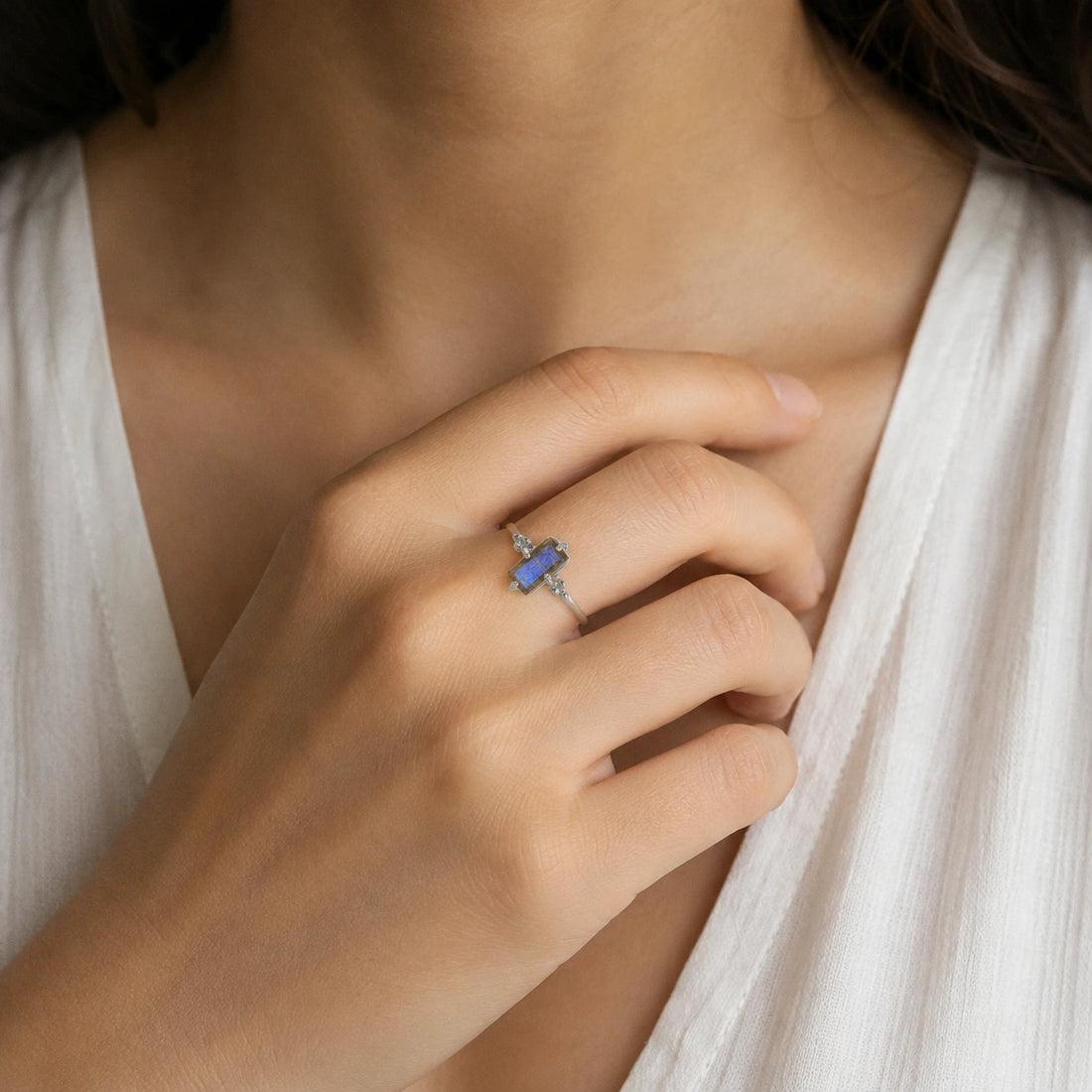 Labradorite_ring_with_baguette_shaped_labradorite_stone_in_gold_plated_silver_at_slight_angle_view_on_soft_fabric_background