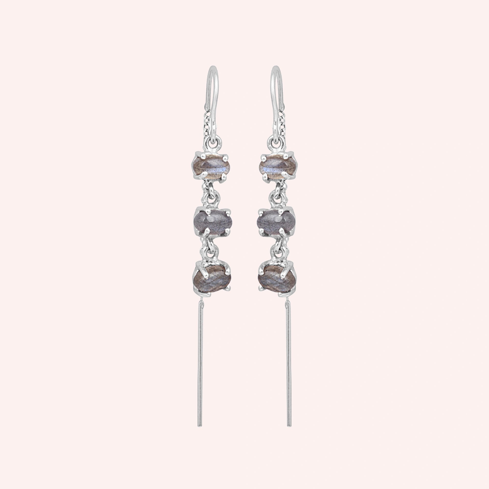 Threader earrings silver chain design with three linked labradorite stones viewed slightly angled on soft white fabric