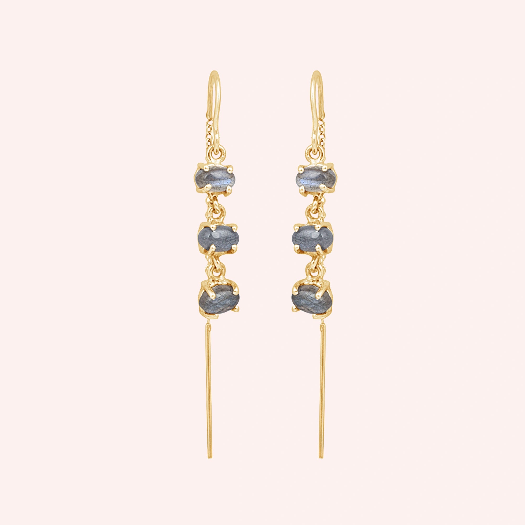 Gold plated threader earrings with a chain design with three linked labradorite stones viewed straight on a light pink background