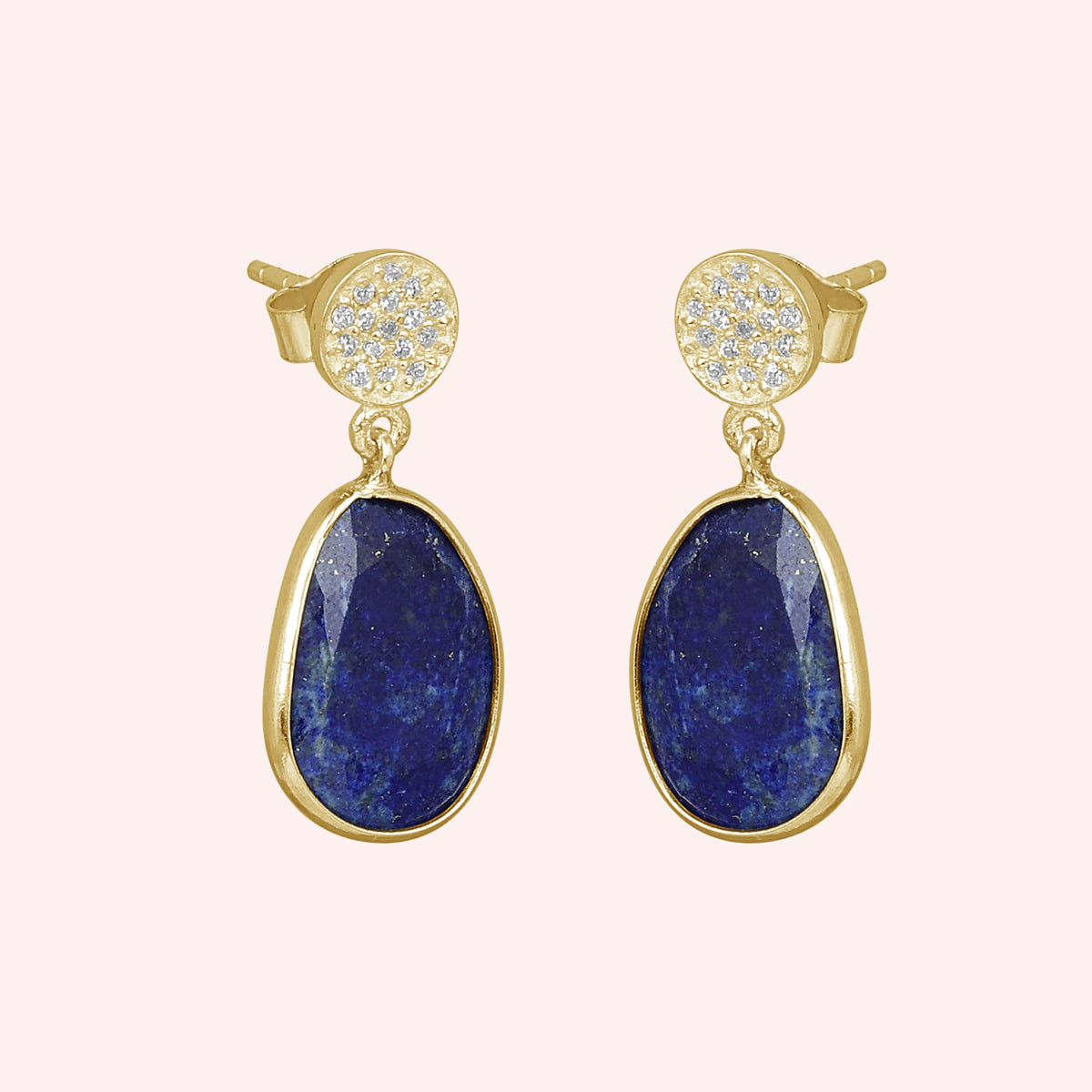 Lapis_lazuli_earrings_in_gold_plated_silver_with_lapis_lazuli_and_cz_stones_in_slight_angle_on_a_solid_pink_background