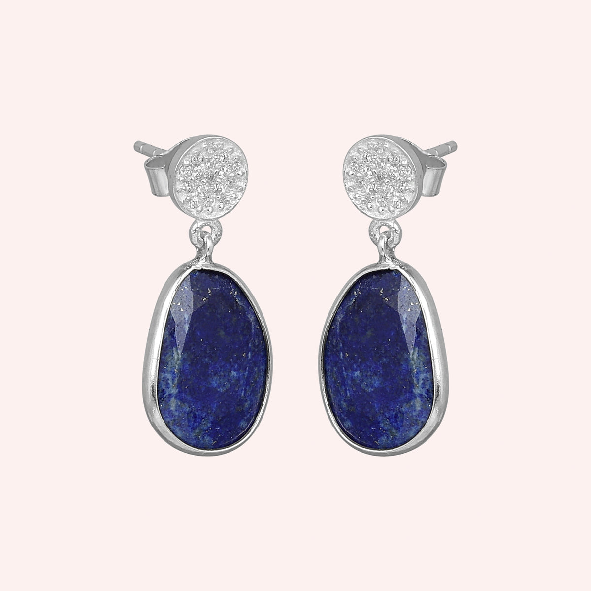 Lapis_lazuli_earrings_in_sterling_silver_with_lapis_lazuli_and_cz_stones_in_slight_angle_on_a_solid_pink_background