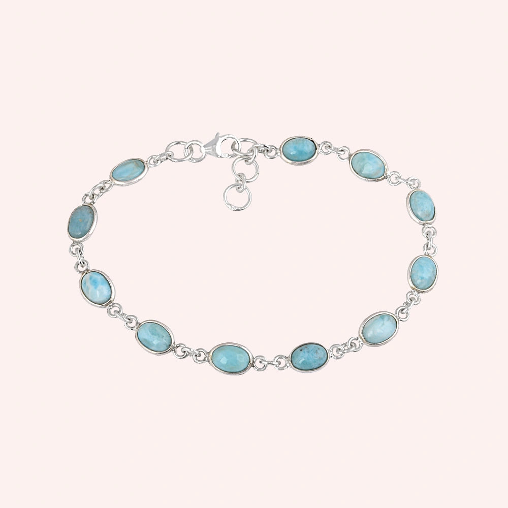 Larimar bracelet sterling silver oval links gemstone chain on light pink background from a straight product angle view