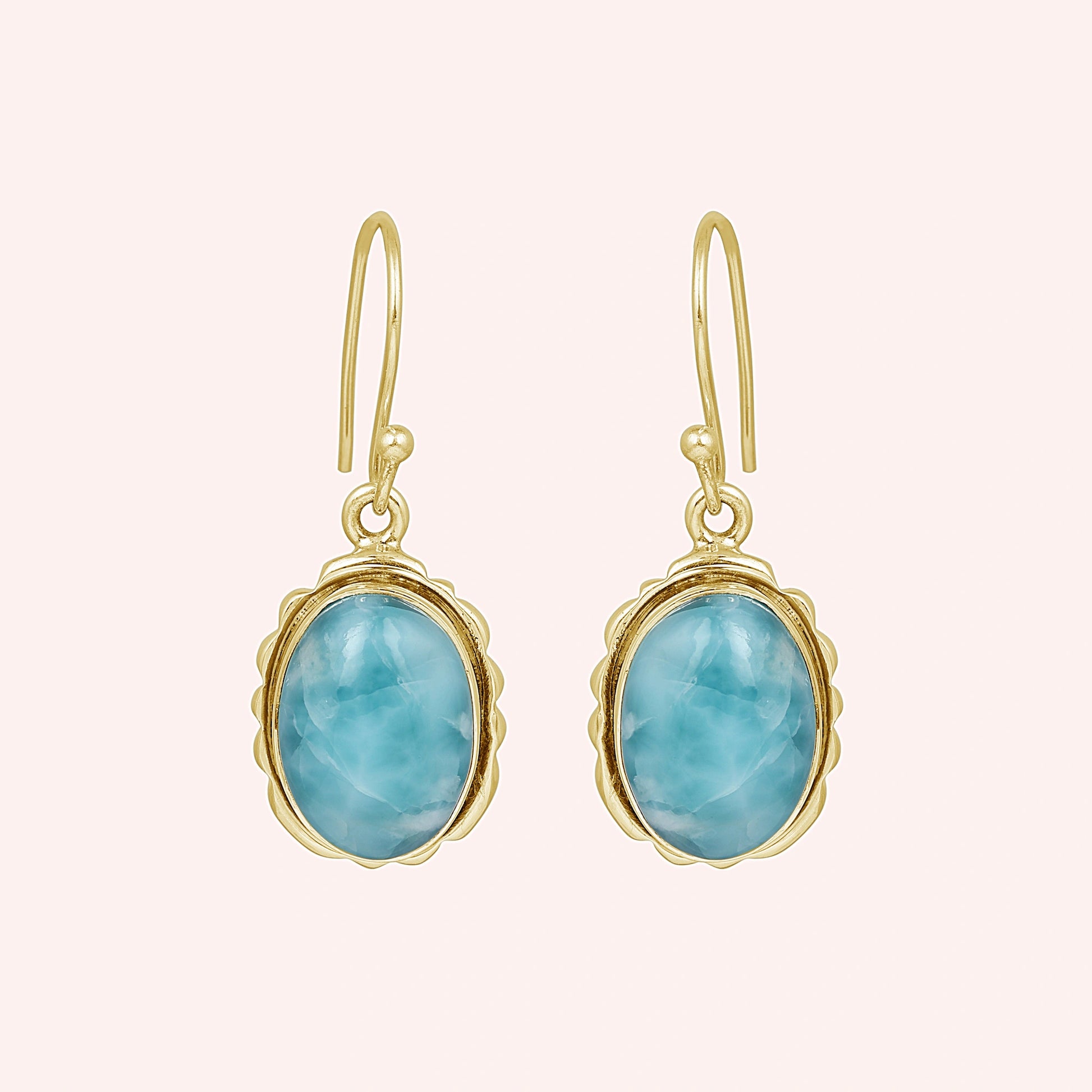 Silver dangling earring sterling silver drop earrings gold plating with oval larimar on a light pink background view