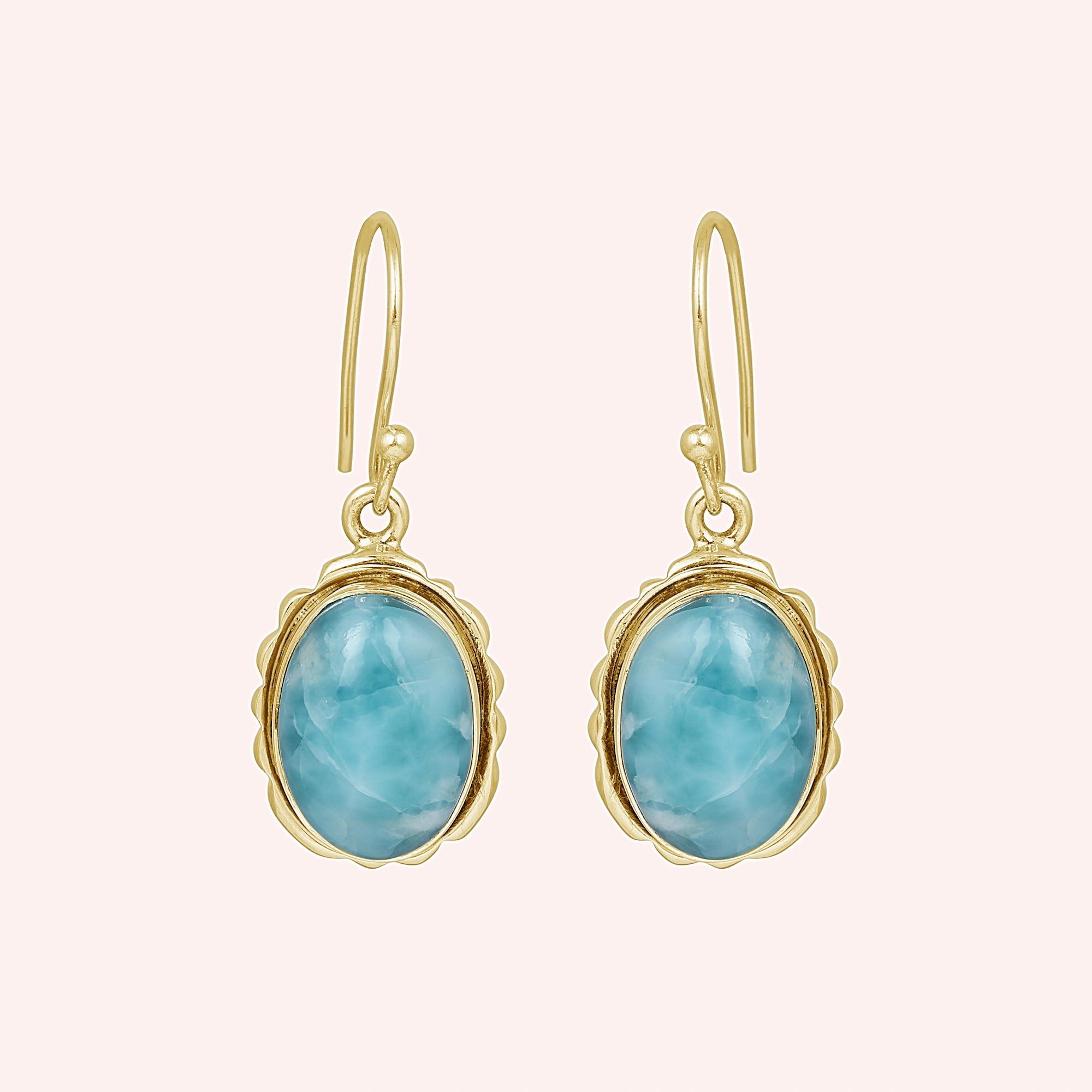 Silver dangling earring sterling silver drop earrings gold plating with oval larimar on a light pink background view