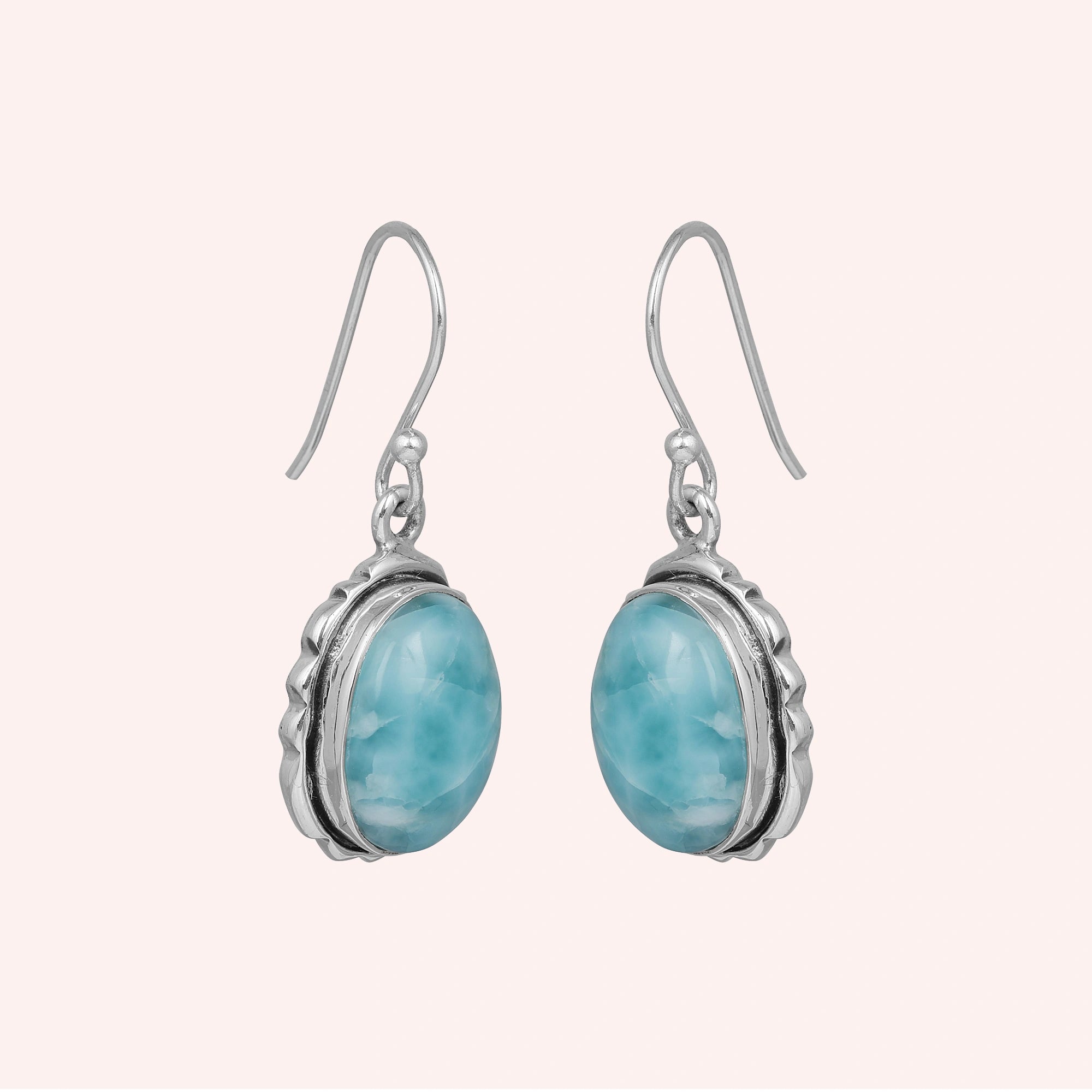 Silver dangling earring sterling silver drop earrings with oval larimar stones on a light pink studio background