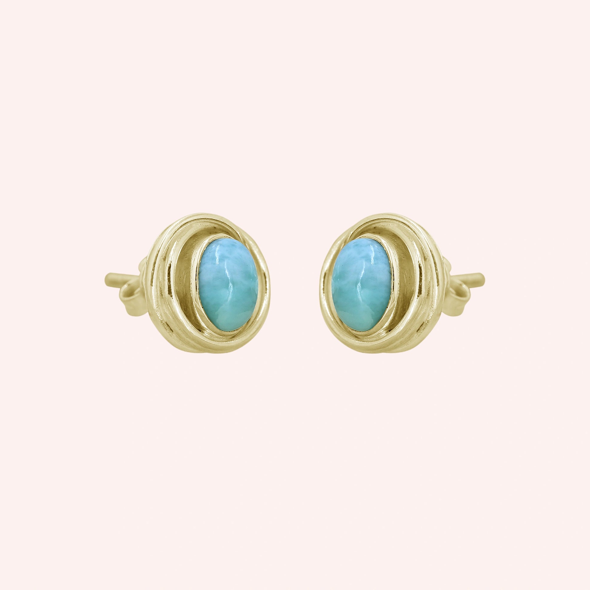 Larimar_earrings_gold_plated_silver_stud_design_with_oval_larimar_stone_shown_slightly_angled_on_solid_pink_background