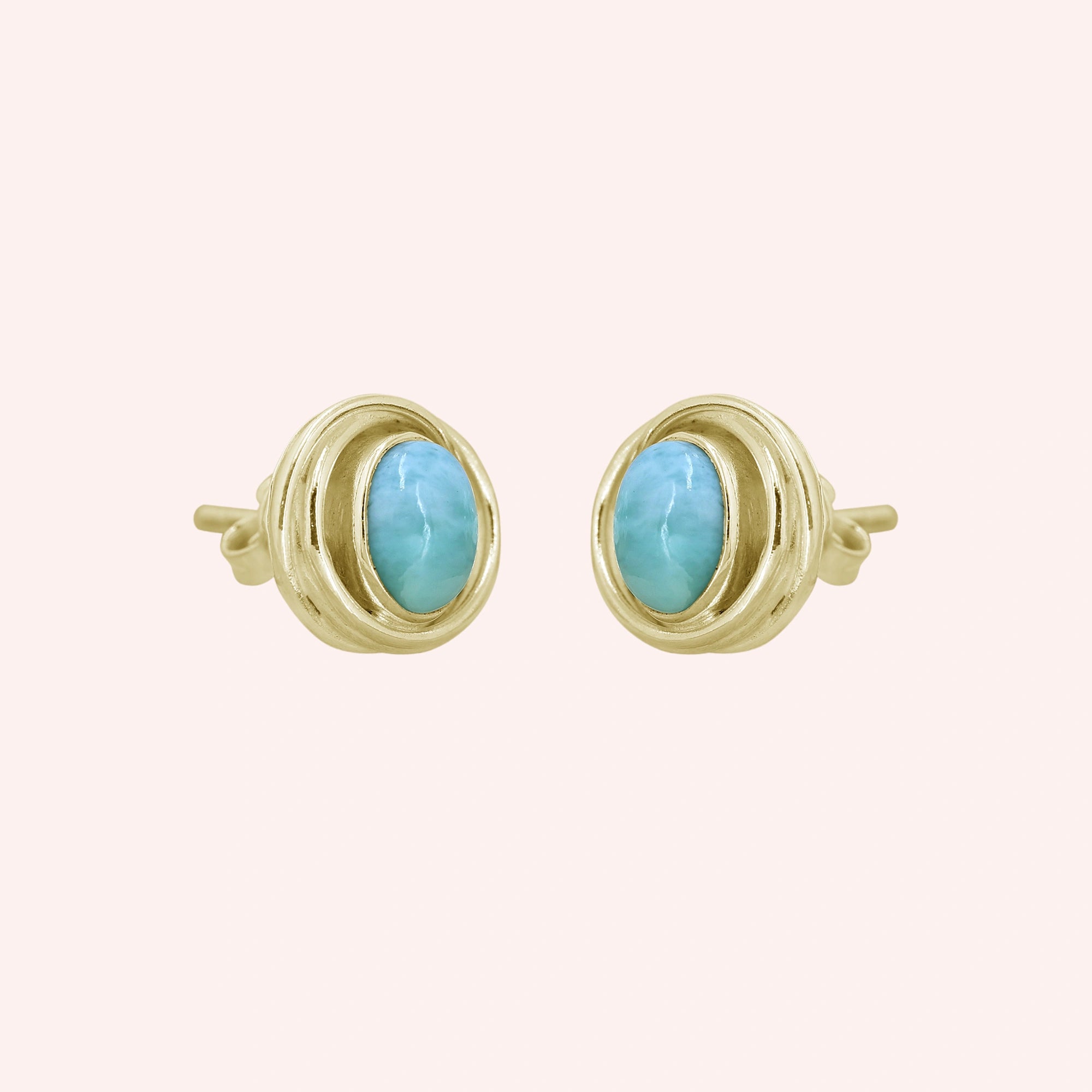 Larimar_earrings_gold_plated_silver_stud_design_with_oval_larimar_stone_shown_slightly_angled_on_solid_pink_background
