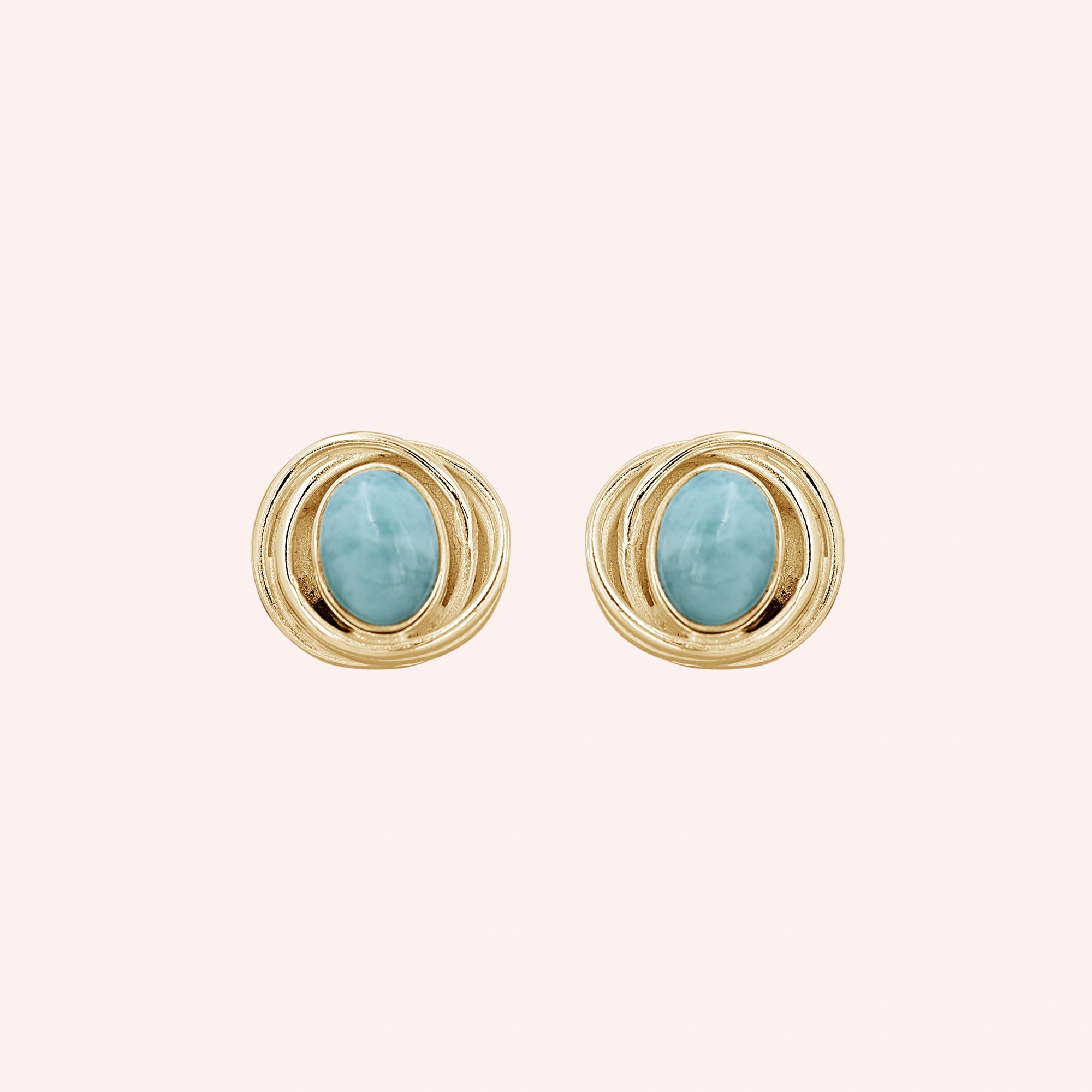 Larimar_earrings_gold_plated_silver_stud_design_with_oval_larimar_stone_shown_at_front_angle_on_solid_pink_background