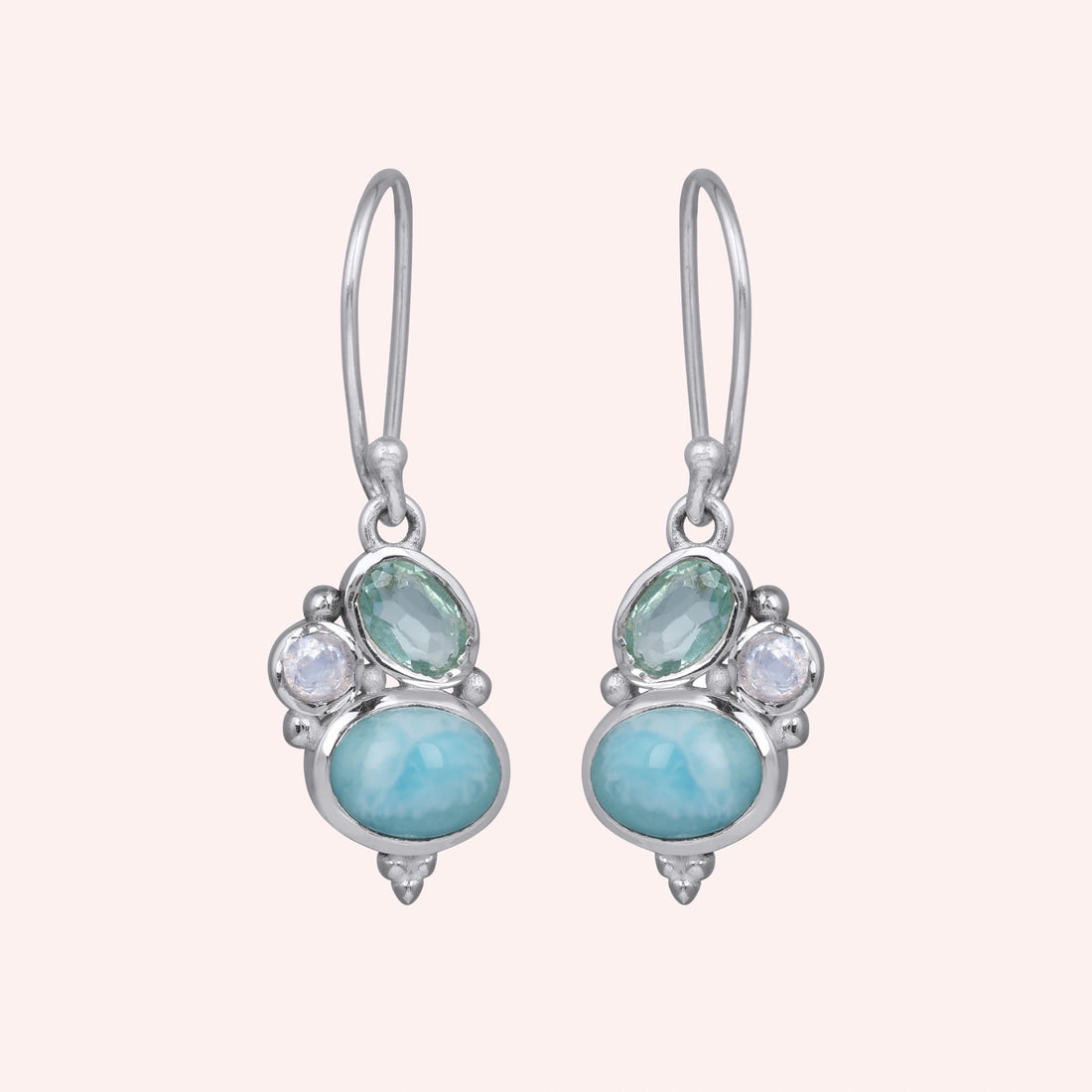 Boho dangle earrings with a sterling silver trio gemstones larimar moonstone blue topaz on white fabric from a straight angle view