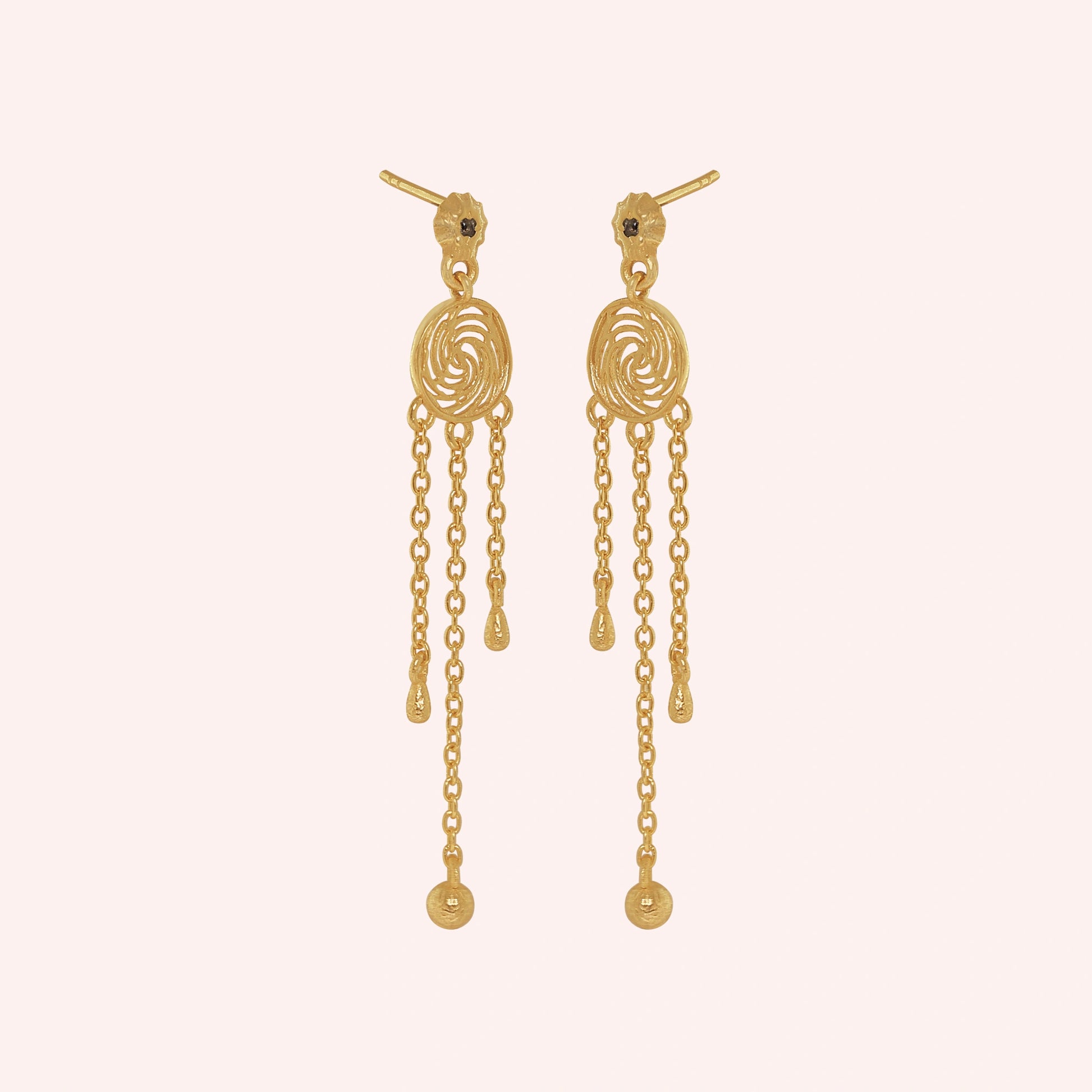 Long_chain_earrings_in_gold_plated_silver_featuring_smoky_quartz_stone_at_slight_angle_on_solid_pink_background