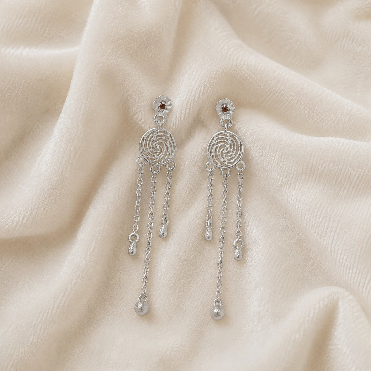 Long_chain_earrings_in_sterling_silver_featuring_smoky_quartz_stone_at_front_angle_on_soft_fabric_background