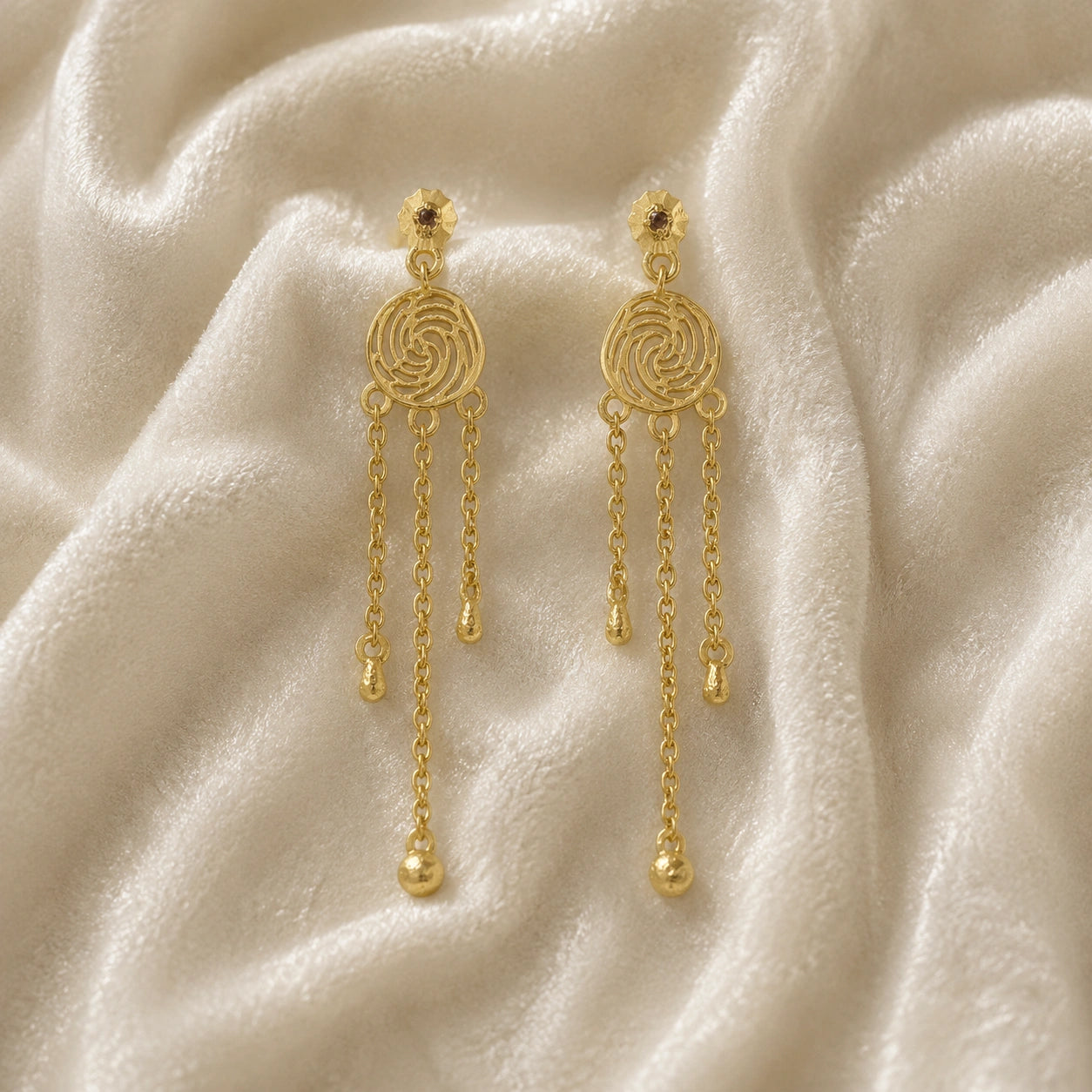 Long_chain_earrings_in_gold_plated_silver_featuring_smoky_quartz_stone_at_front_angle_on_soft_fabric_background