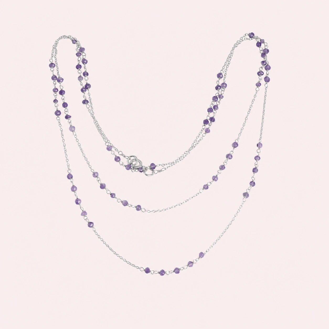 Long_chain_necklace_in_sterling_silver_with_amethyst_beads_at_front_angle_view_on_solid_pink_background