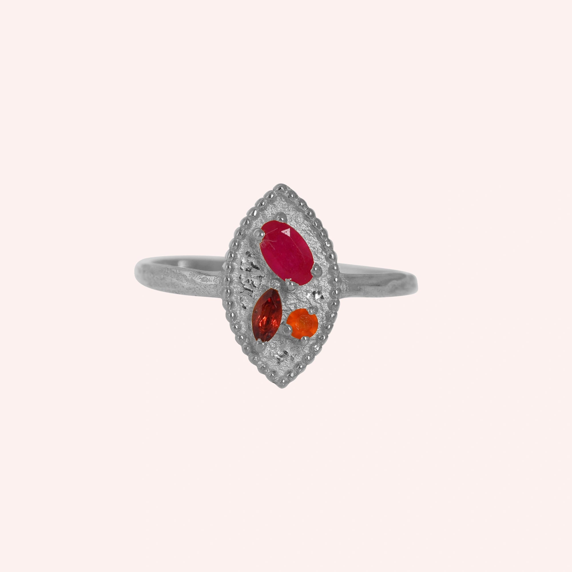Marquise-ring-with-ruby-garnet-and-carnelian-stones-sterling-silver-front-view-on-soft-pink-background