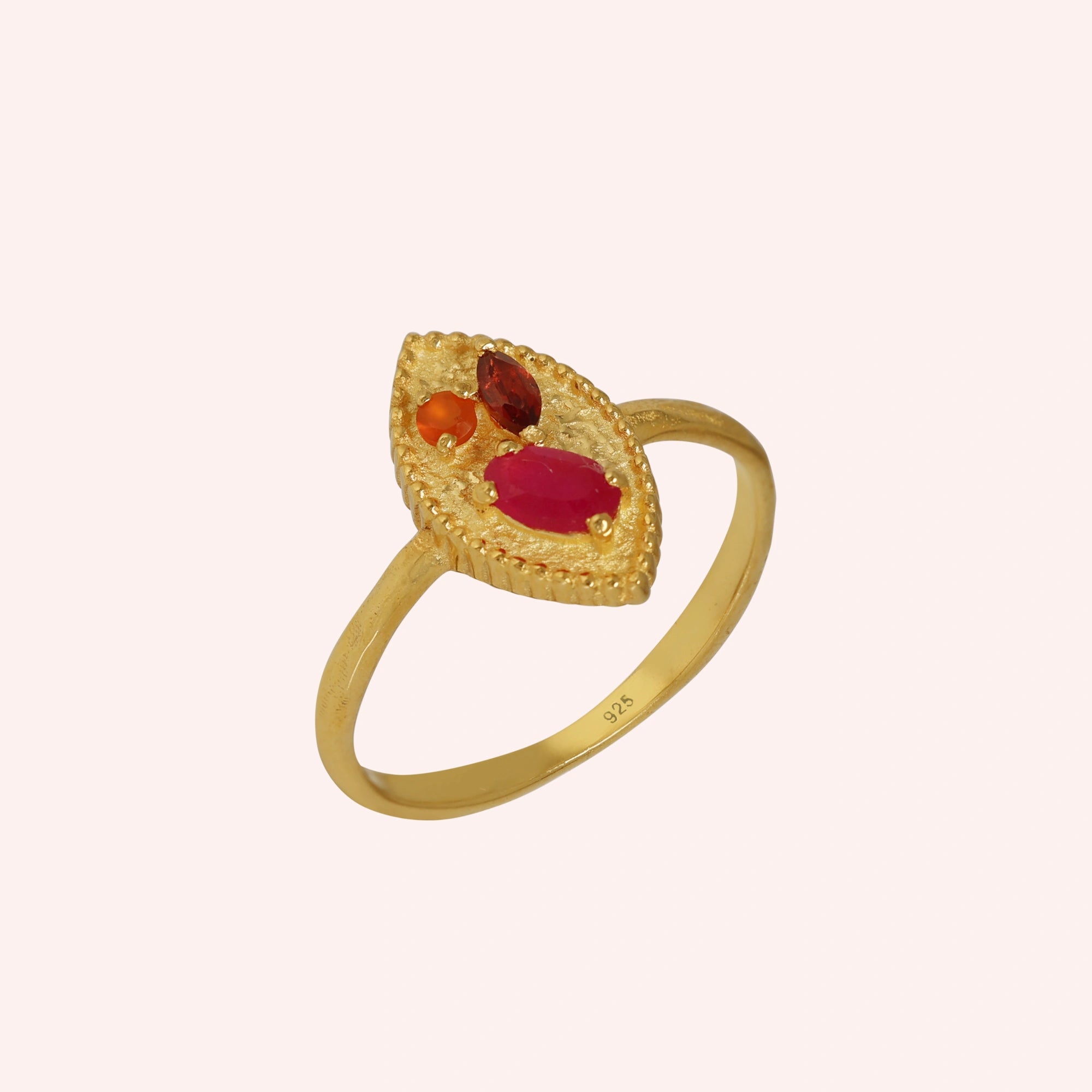 Marquise-ring-with-ruby-garnet-and-carnelian-stones-gold-plated-silver-angled-view-on-soft-pink-background