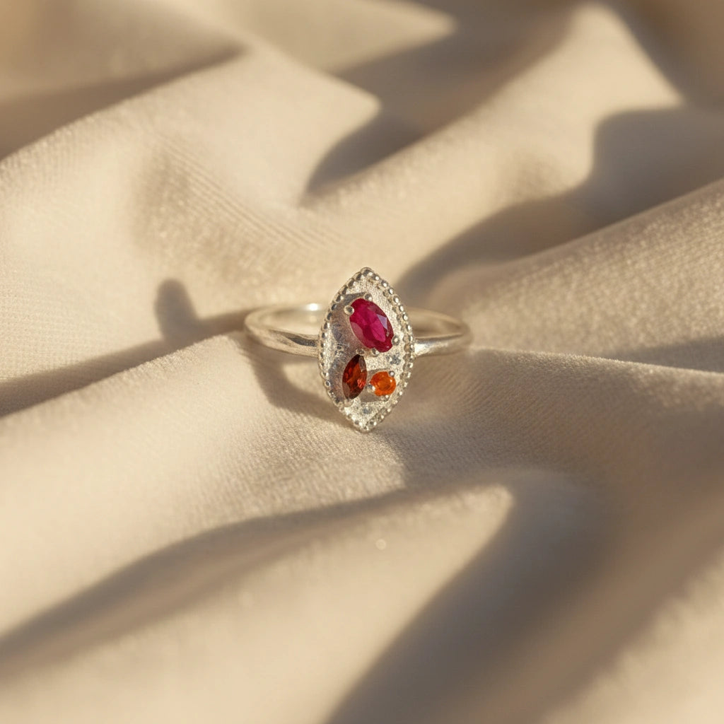 Marquise-ring-with-ruby-garnet-and-carnelian-stones-sterling-silver-front-view-on-white-satin-background