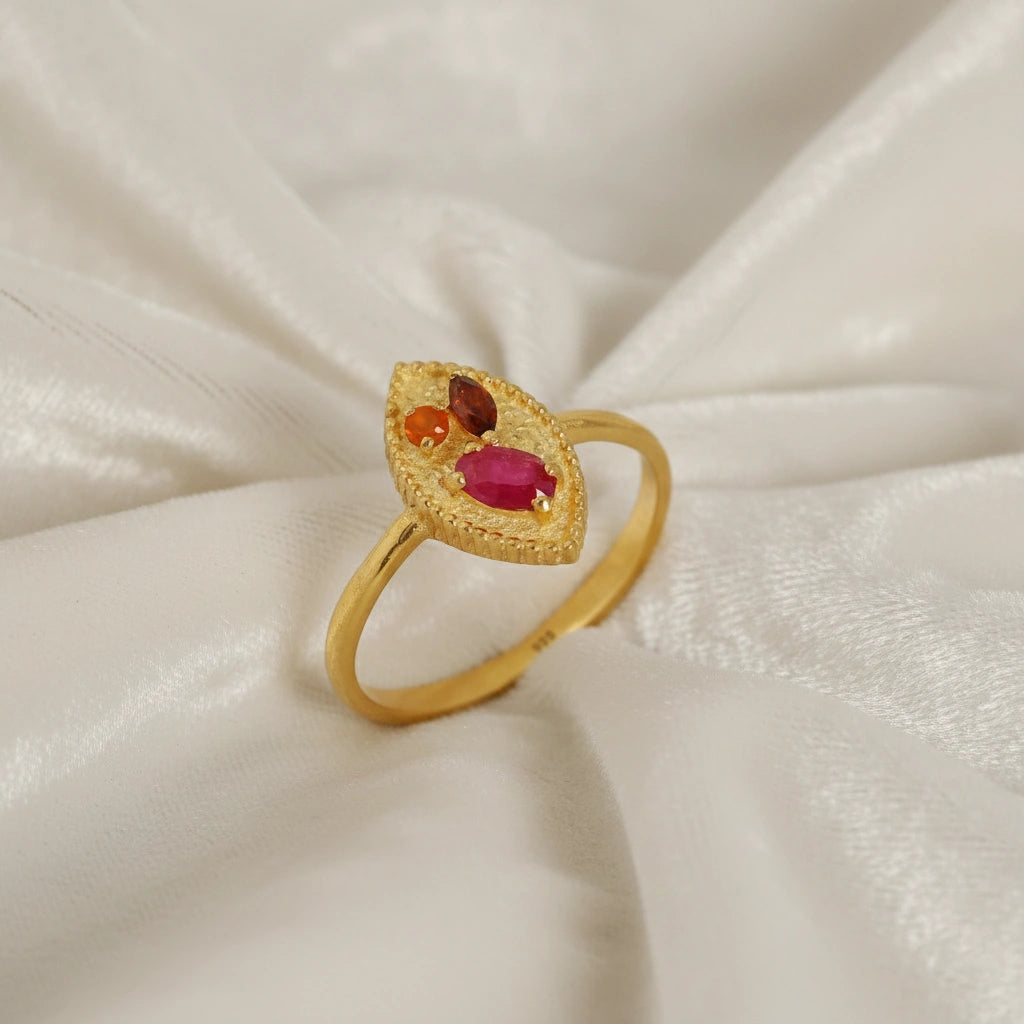 Marquise-ring-with-ruby-garnet-and-carnelian-stones-gold-plated-silver-angled-view-on-white-satin-background