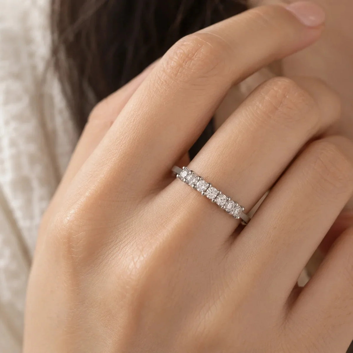Minimal_ring_in_sterling_silver_with_square_cut_lab_grown_diamonds_at_front_angle_view_worn_by_a_model