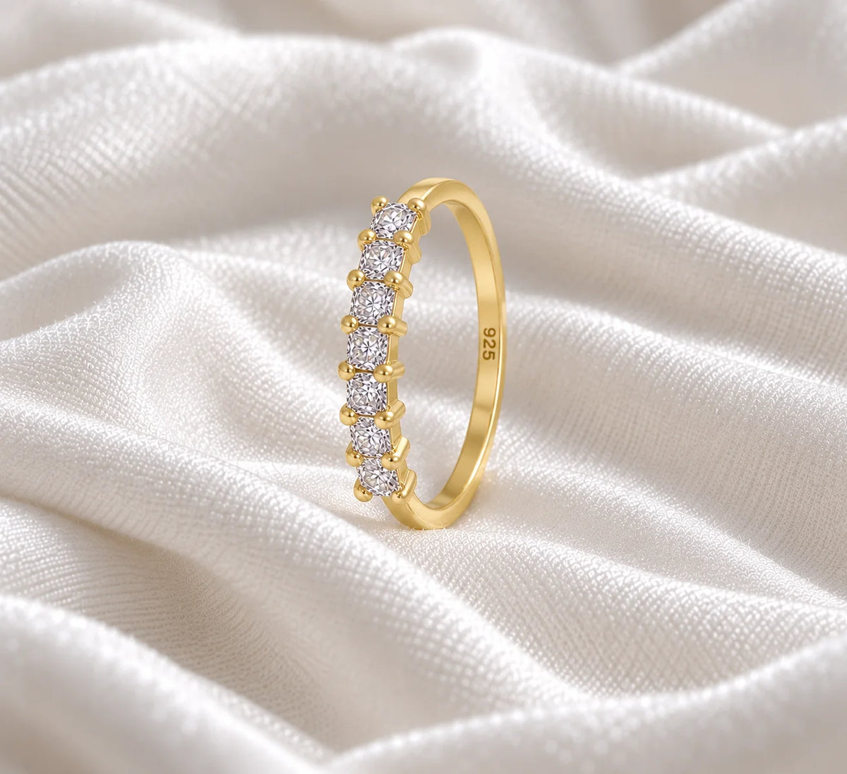 Minimal_ring_in_gold_plated_silver_with_square_cut_lab_grown_diamonds_at_side_angle_view_on_soft_fabric_background