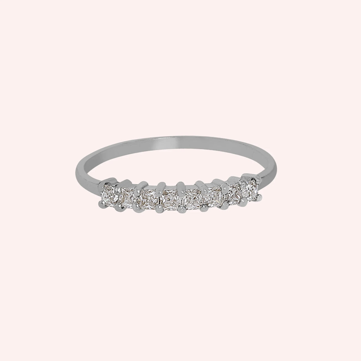 Minimal_ring_in_sterling_silver_with_square_cut_CZ_stones_at_front_angle_view_on_solid_pink_background