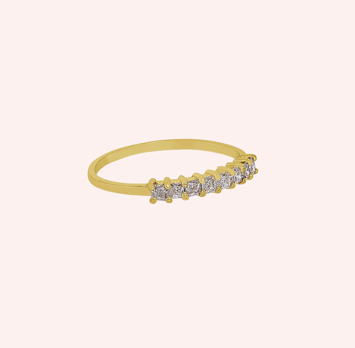 Minimal_ring_in_gold_plated_silver_with_square_cut_lab_grown_diamonds_at_side_angle_view_on_solid_pink_background