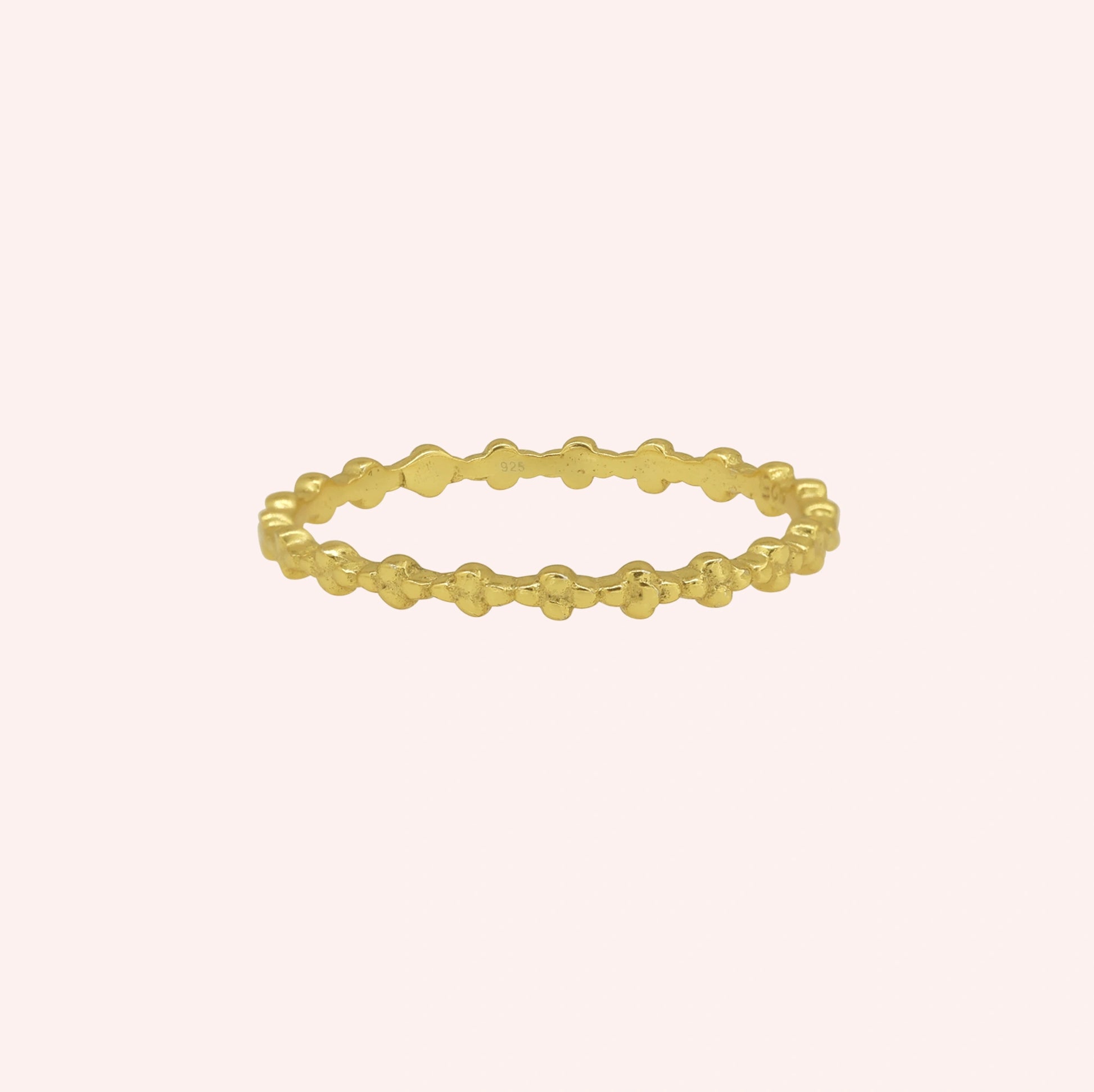 Minimal_ring_in_gold_plated_silver_at_front_angle_on_solid_pink_background