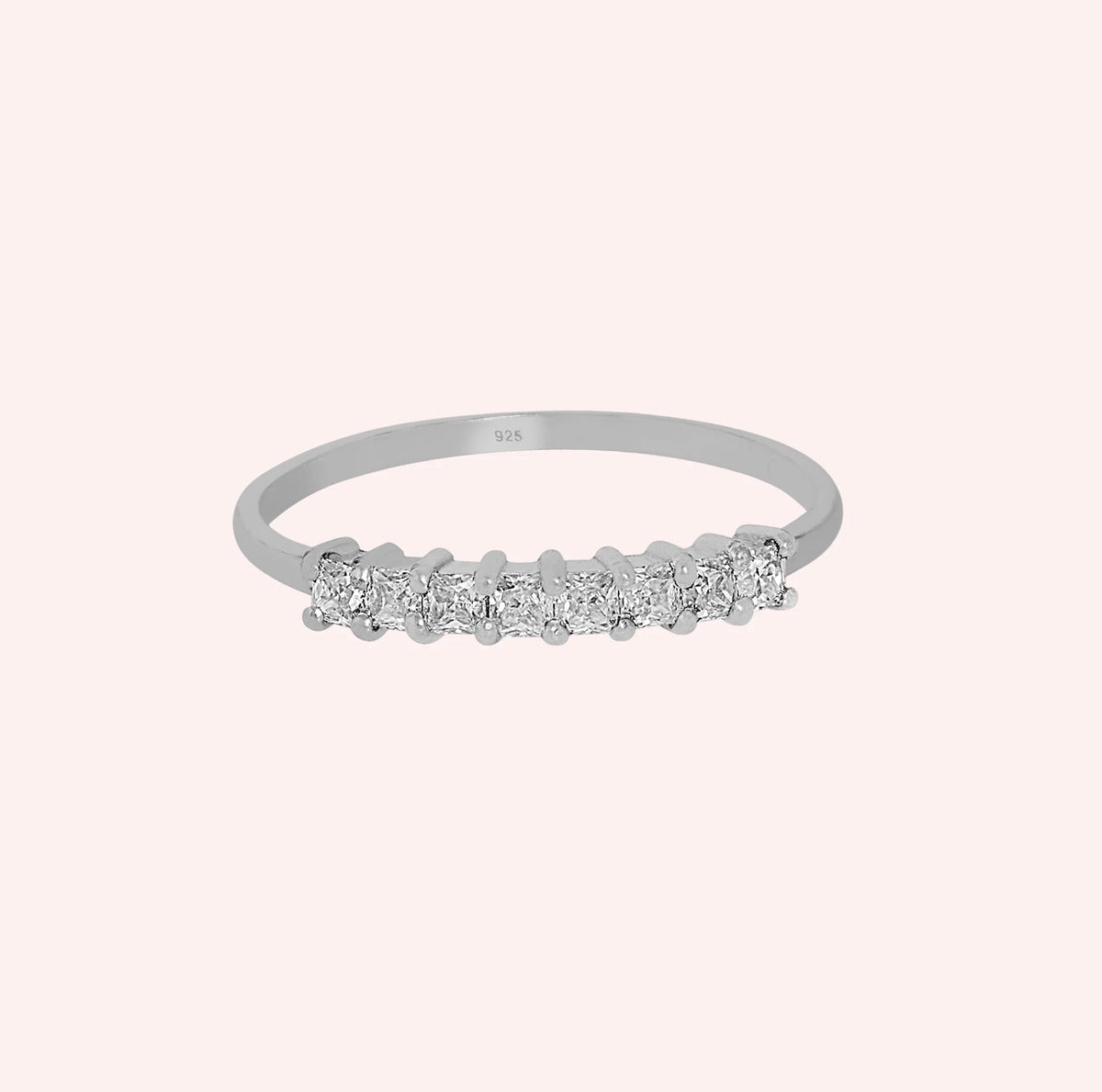 Minimal_ring_in_sterling_silver_with_square_cut_lab_grown_diamonds_at_front_angle_view_on_solid_pink_background