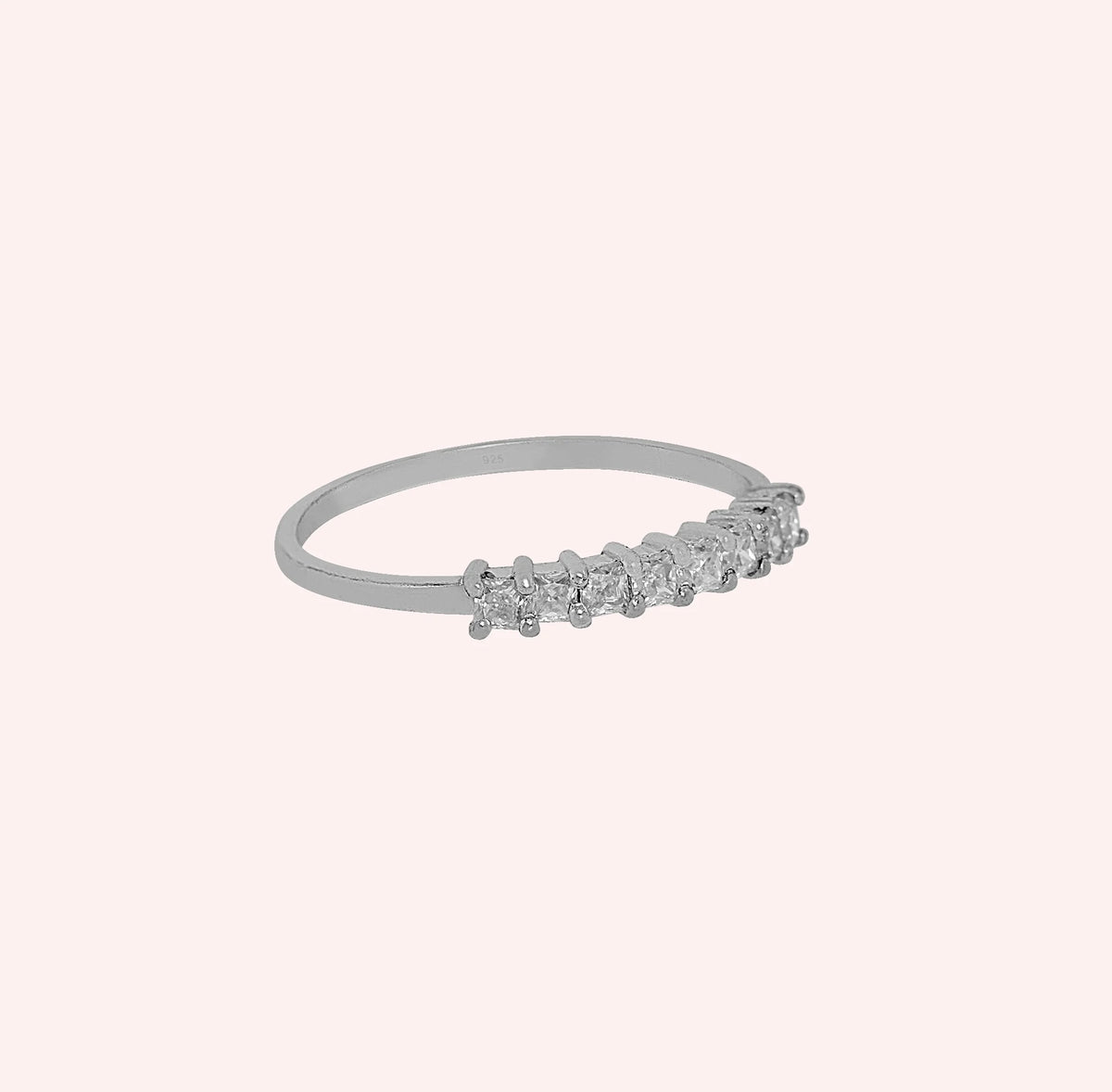 Minimal_ring_in_sterling_silver_with_square_cut_lab_grown_diamonds_at_side_angle_view_on_solid_pink_background