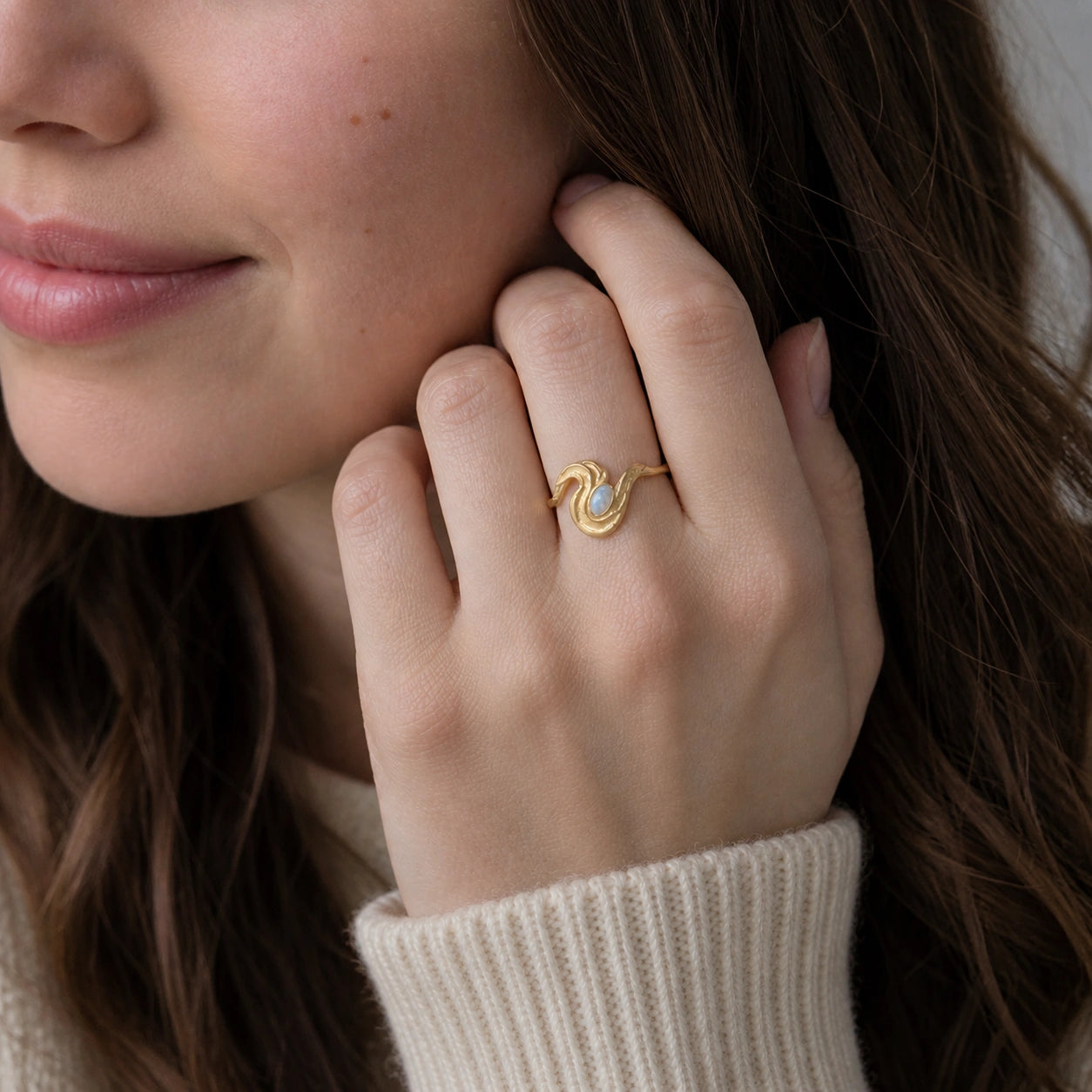 Moonstone_designer_ring_in_gold_plated_silver_with_moonstone_and_wave_band_worn_by_a_model