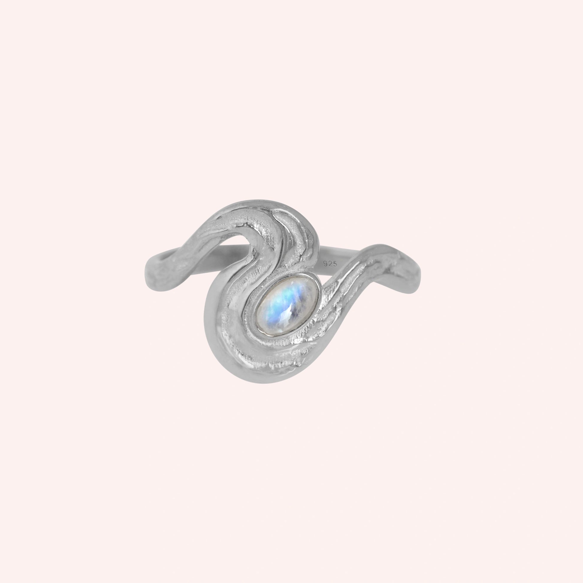 Moonstone_designer_ring_in_gold_plated_silver_with_moonstone_and_wave_band_shown_at_front_angle_view_on_solid_pink_background