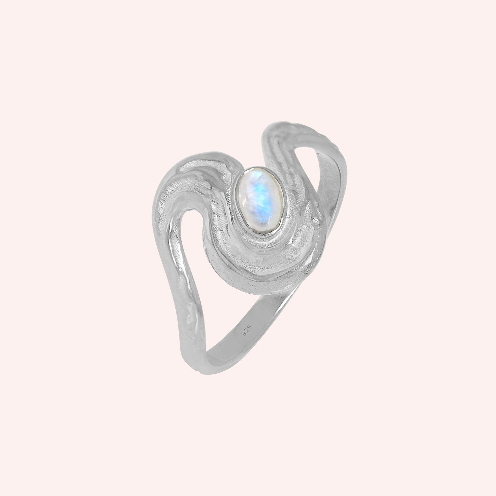 Moonstone_designer_ring_in_gold_plated_silver_with_moonstone_and_wave_band_shown_slightly_tilted_solid_pink_background