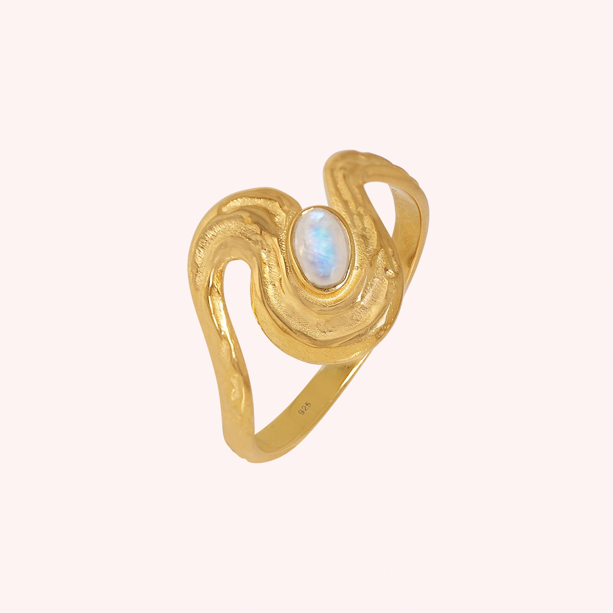 Moonstone_designer_ring_in_gold_plated_silver_with_moonstone_and_wave_band_shown_slightly_tilted_solid_pink_background