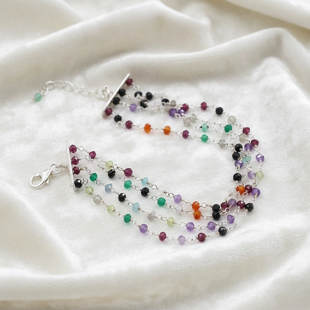 Tourmaline_bracelet_in_sterling_silver_bracelet_with_multi_tourmaline_stones_in_slight_angle_on_a_white_fabric_background