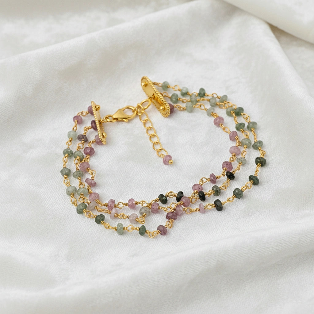 Tourmaline_bracelet_in_gold_plated_silver_bracelet_with_multi_tourmaline_stones_in_front_angle_on_a_white_fabric_background