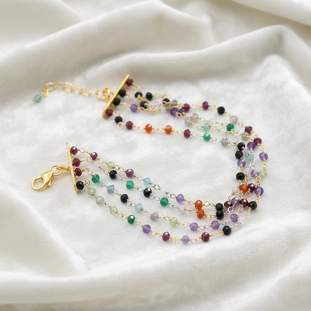 Tourmaline_bracelet_in_gold_plated_silver_bracelet_with_multi_tourmaline_stones_in_slight_angle_on_a_white_fabric_background