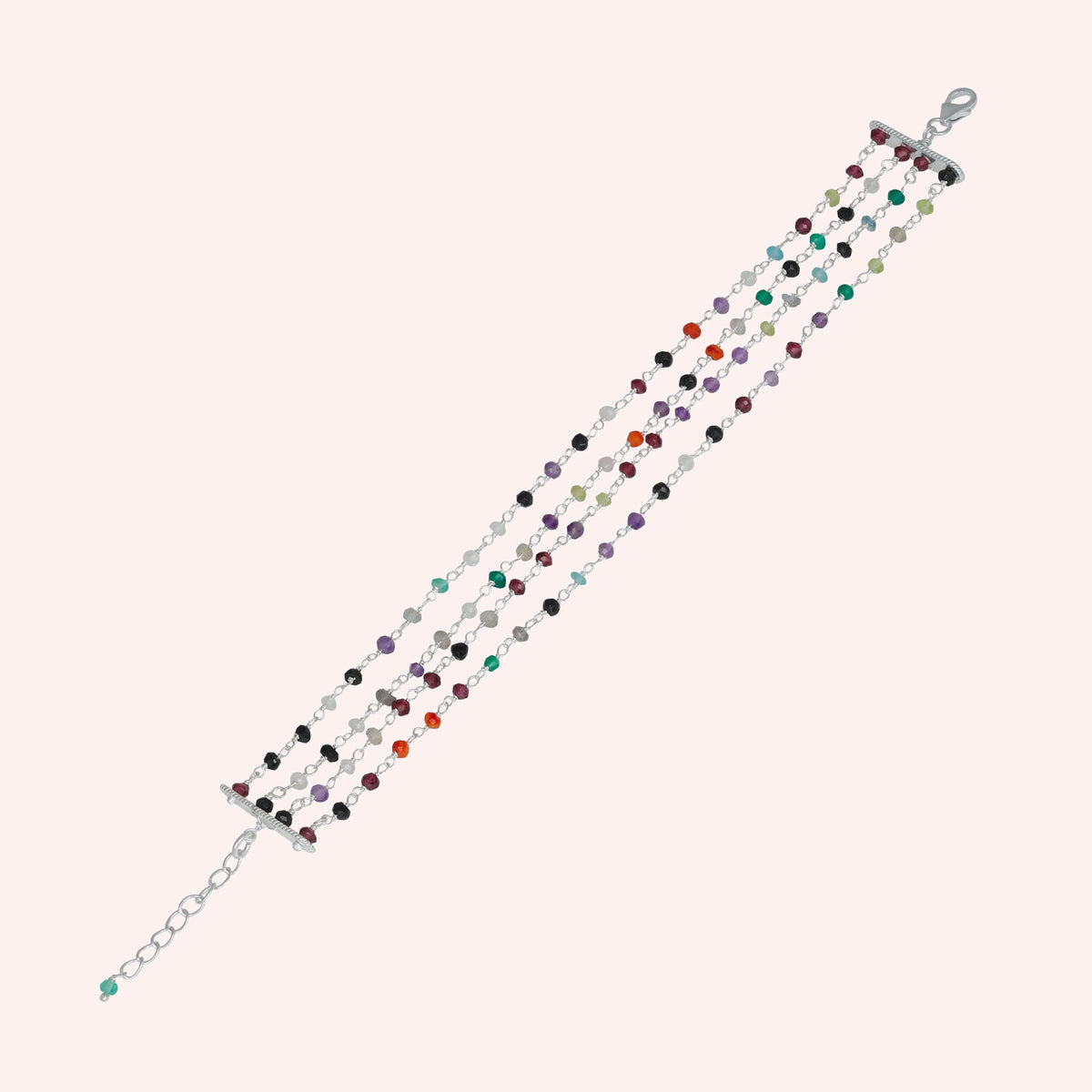 Tourmaline_bracelet_in_sterling_silver_bracelet_with_multi_tourmaline_stones_on_a_solid_pink_background