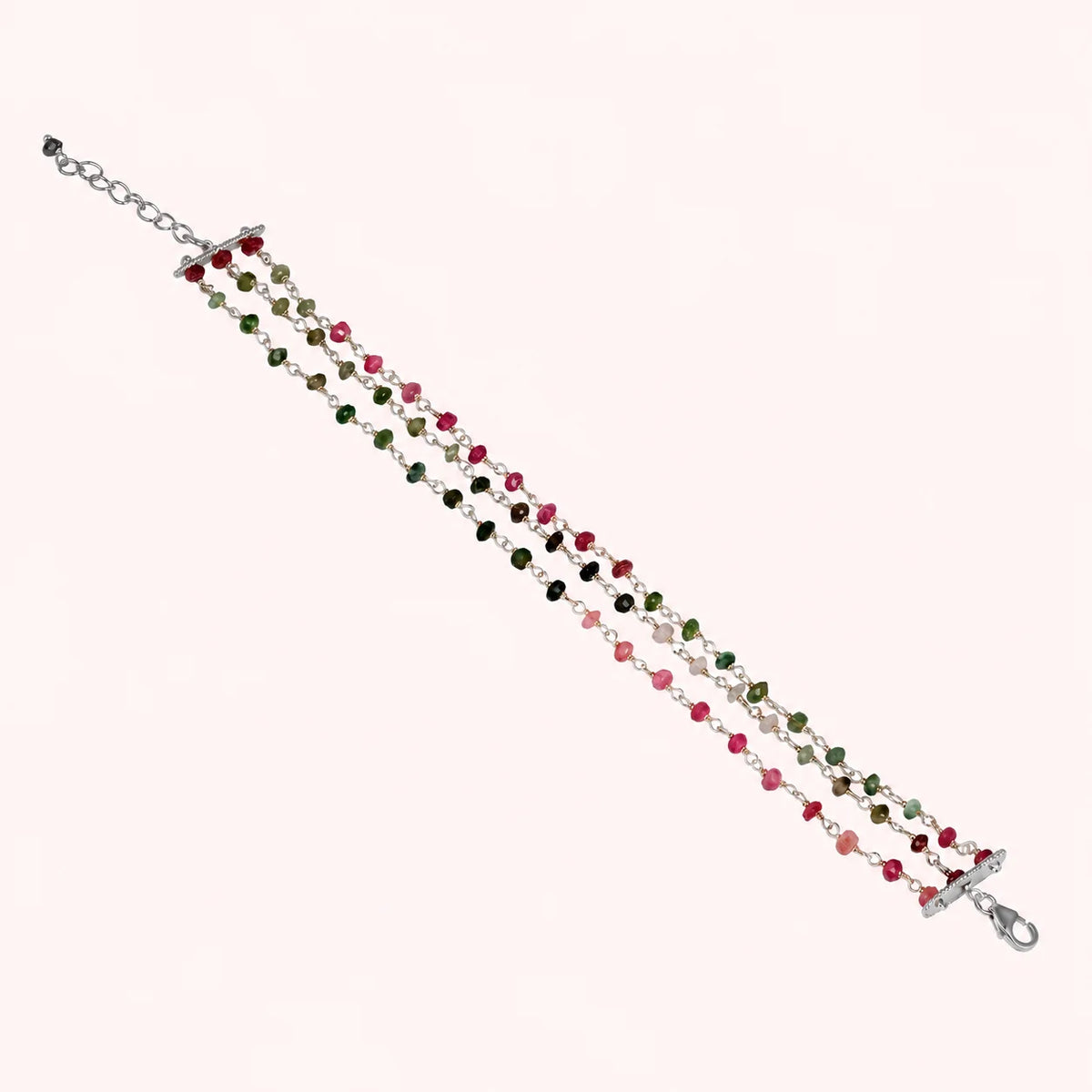 Tourmaline_bracelet_in_sterling_silver_bracelet_with_multi_tourmaline_stones_on_a_solid_pink_background