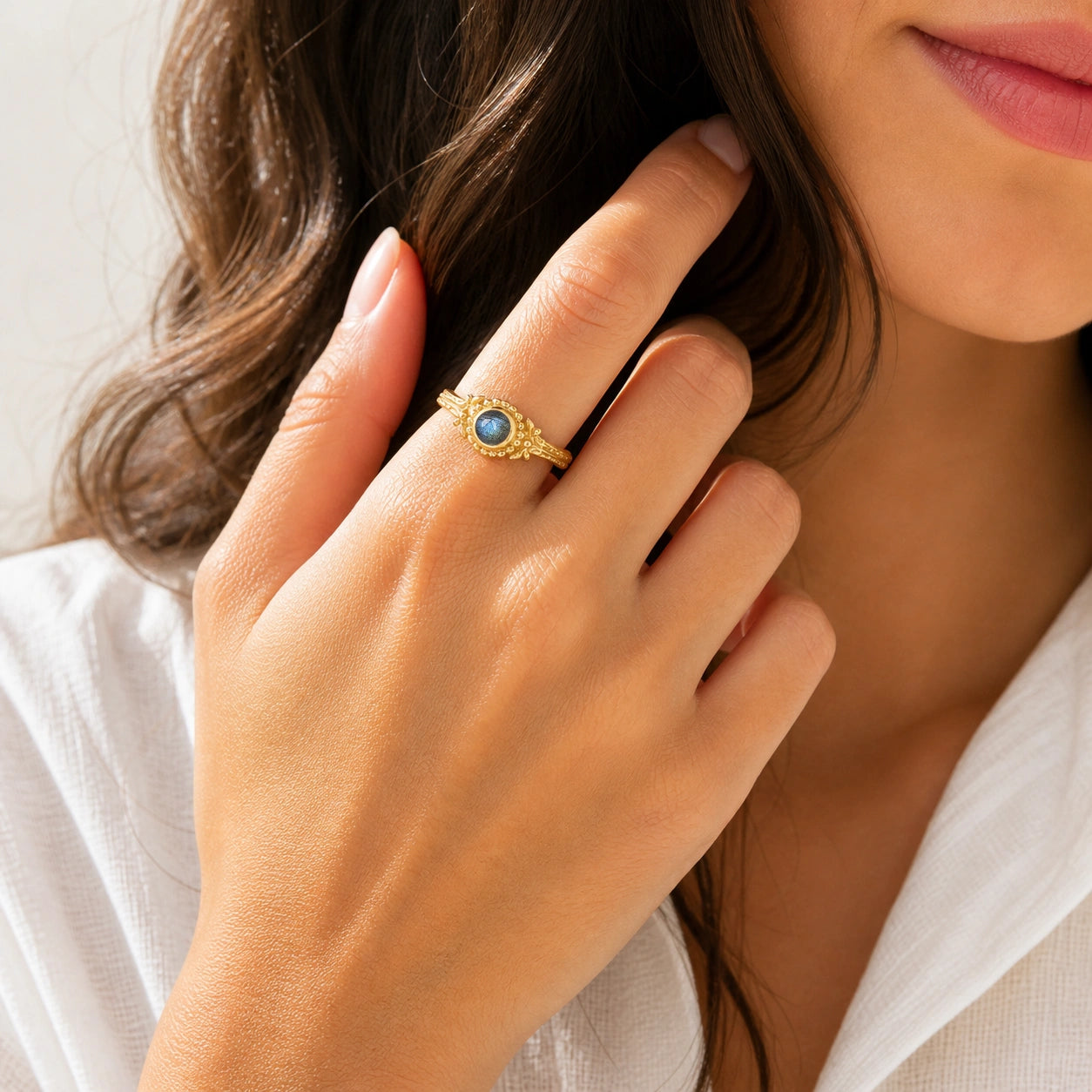 Natural_stone_ring_gold_plated_silver_with_round_labradorite_and_detailed_band_worn_by_a_model