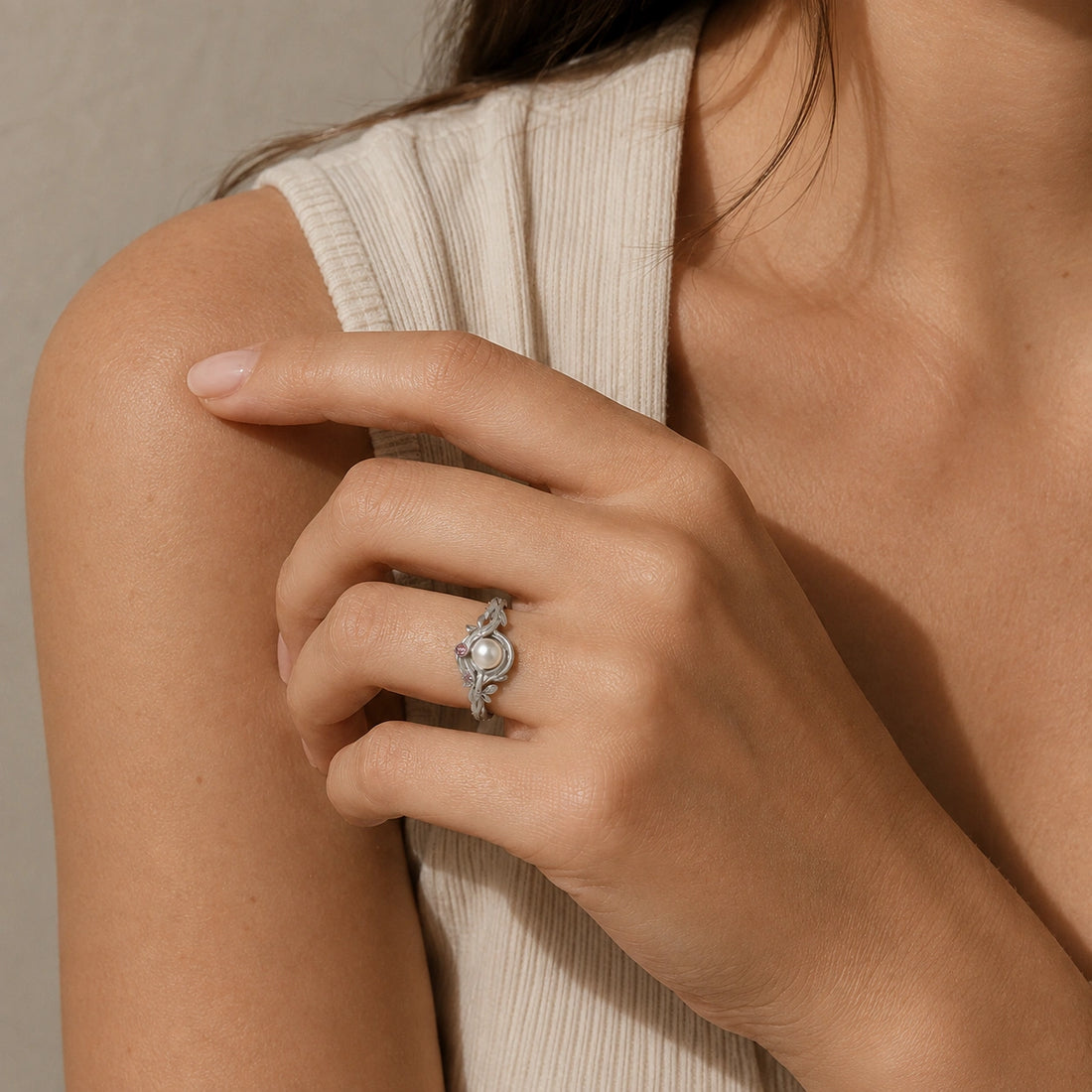 Pearl_ring_in_gold_plated_silver_with_pearl_and_amethyst_stones_in_a_floral_design_at_front_angle_view_on_soft_fabric_background