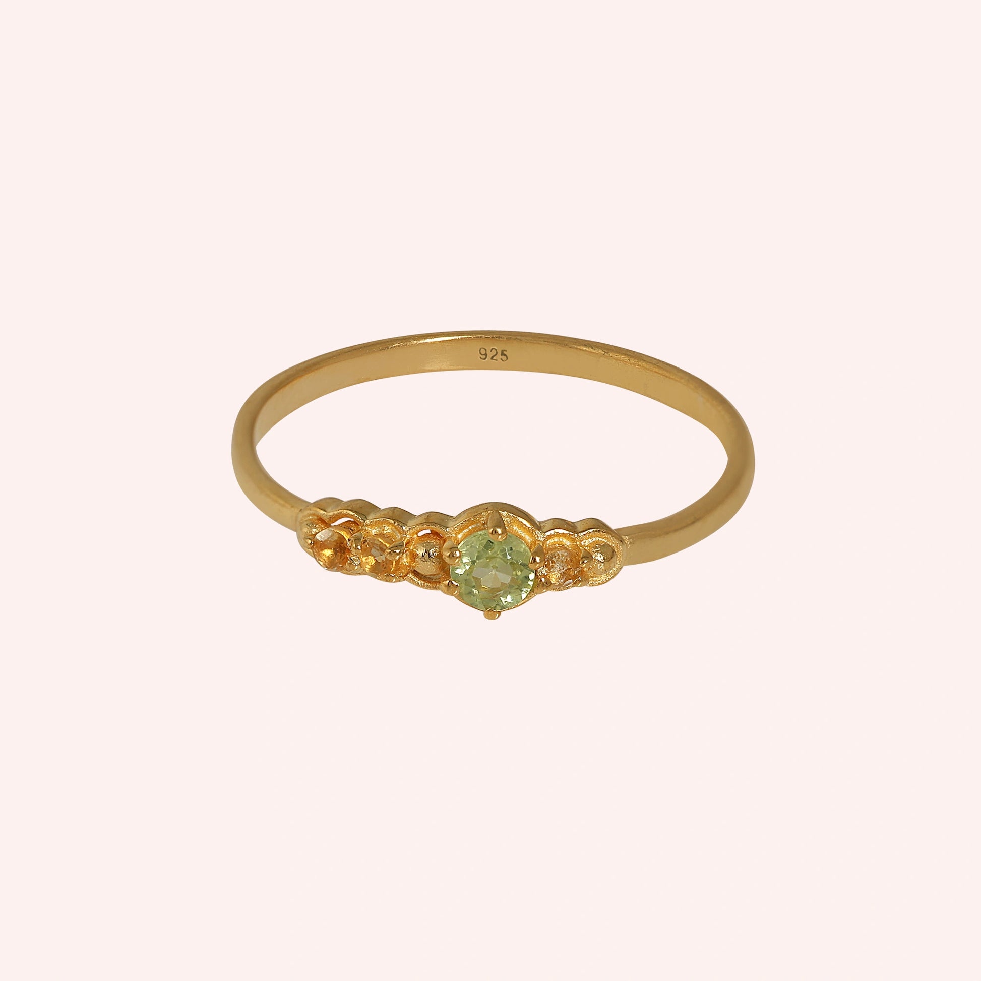 Peridot-ring-with-peridot-and-citrine-gemstones-gold-plated-silver-front-view-on-soft-pink-background