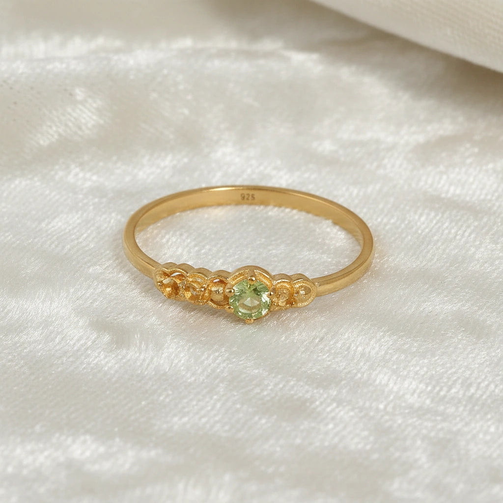 Peridot-ring-with-peridot-and-citrine-gemstones-gold-plated-silver-front-view-on-satin-background