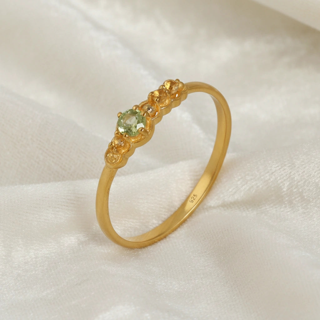 Peridot-ring-with-peridot-and-citrine-gemstones-gold-plated-silver-angled-view-on-satin-background