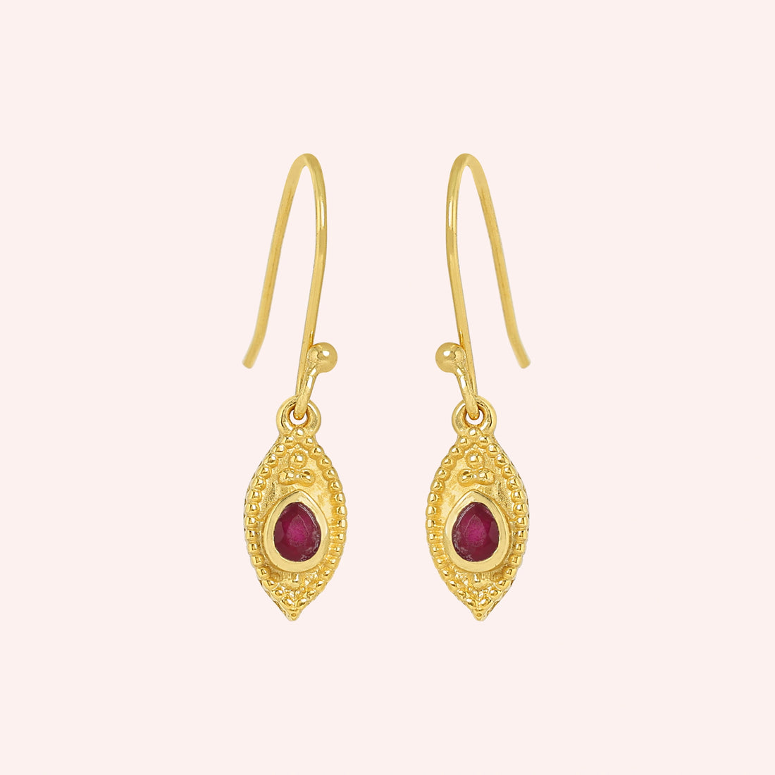 Pink_earrings_in_gold_plated_silver_with_pear_ruby_stones_at_front_angle_view_on_solid_pink_background